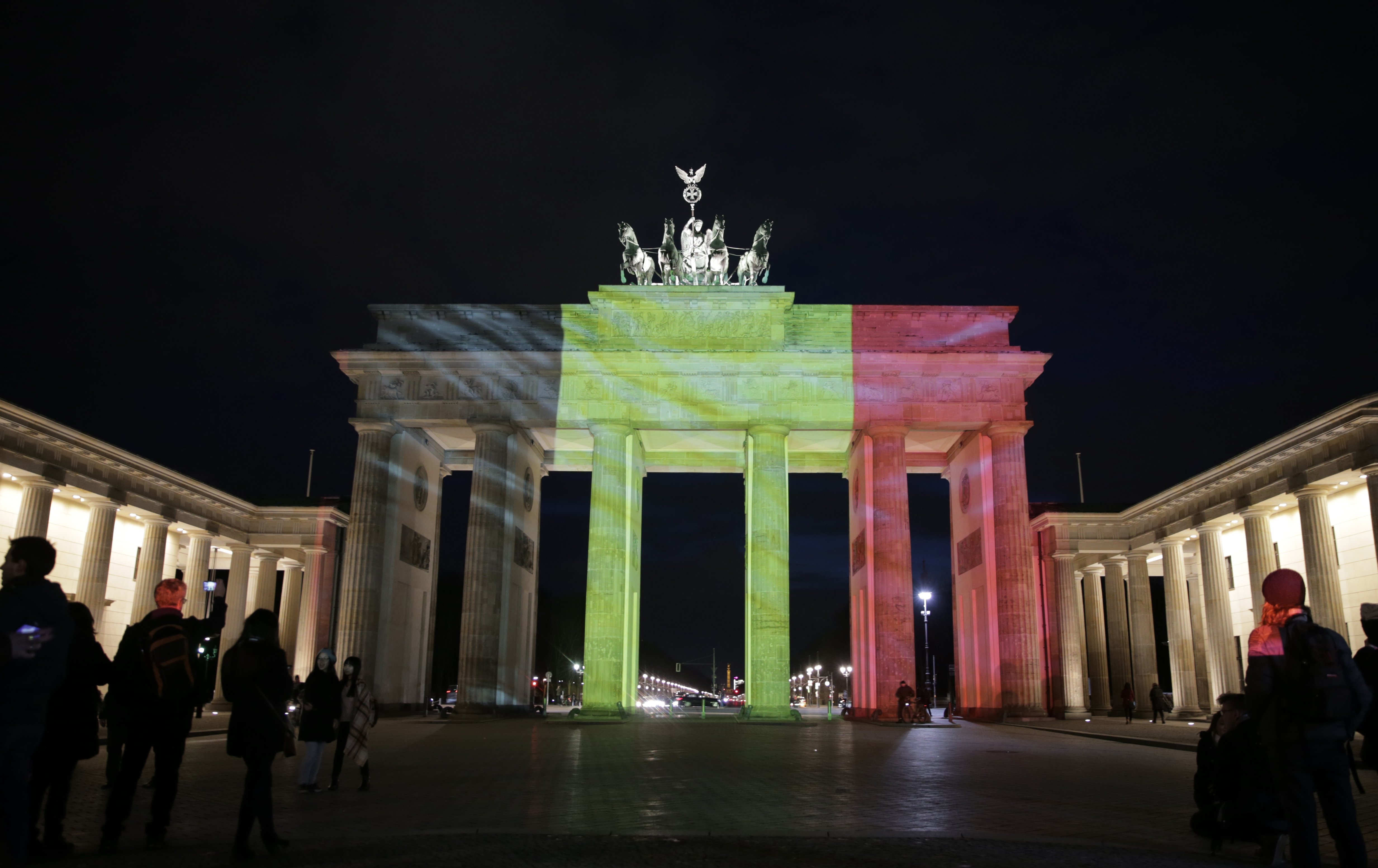 The Brandenburg Gate is illuminated in Belgian national colors in Berlin, on March 22, 2016.