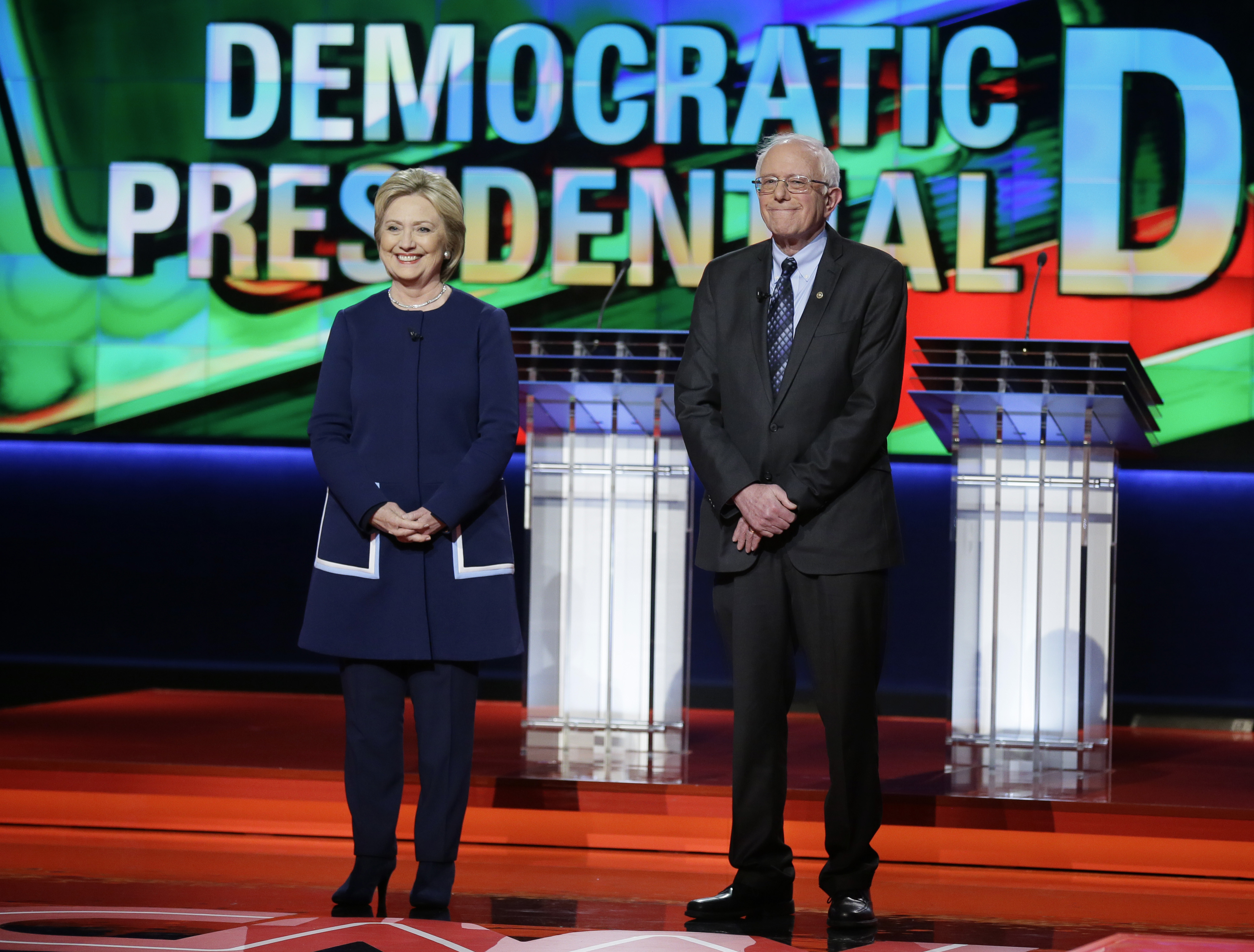 Hillary Clinton and Bernie Sanders stand stage before a Democratic presidential primary debate at the University of Michigan-Flint in Flint, Mich. on March 6, 2016. (Charlie Neibergall—AP)