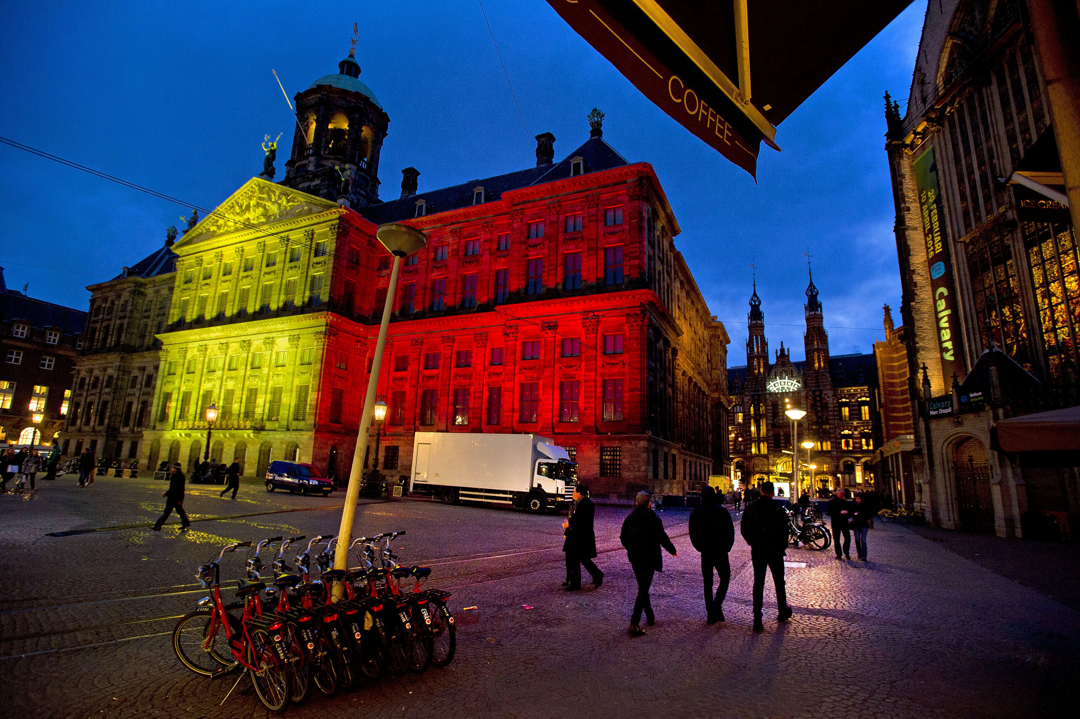 The Royal Palace at Dam Square displays the colors of the Belgian flag in tribute to victims of the Brussels attacks on March 22, 2016 in Amsterdam.