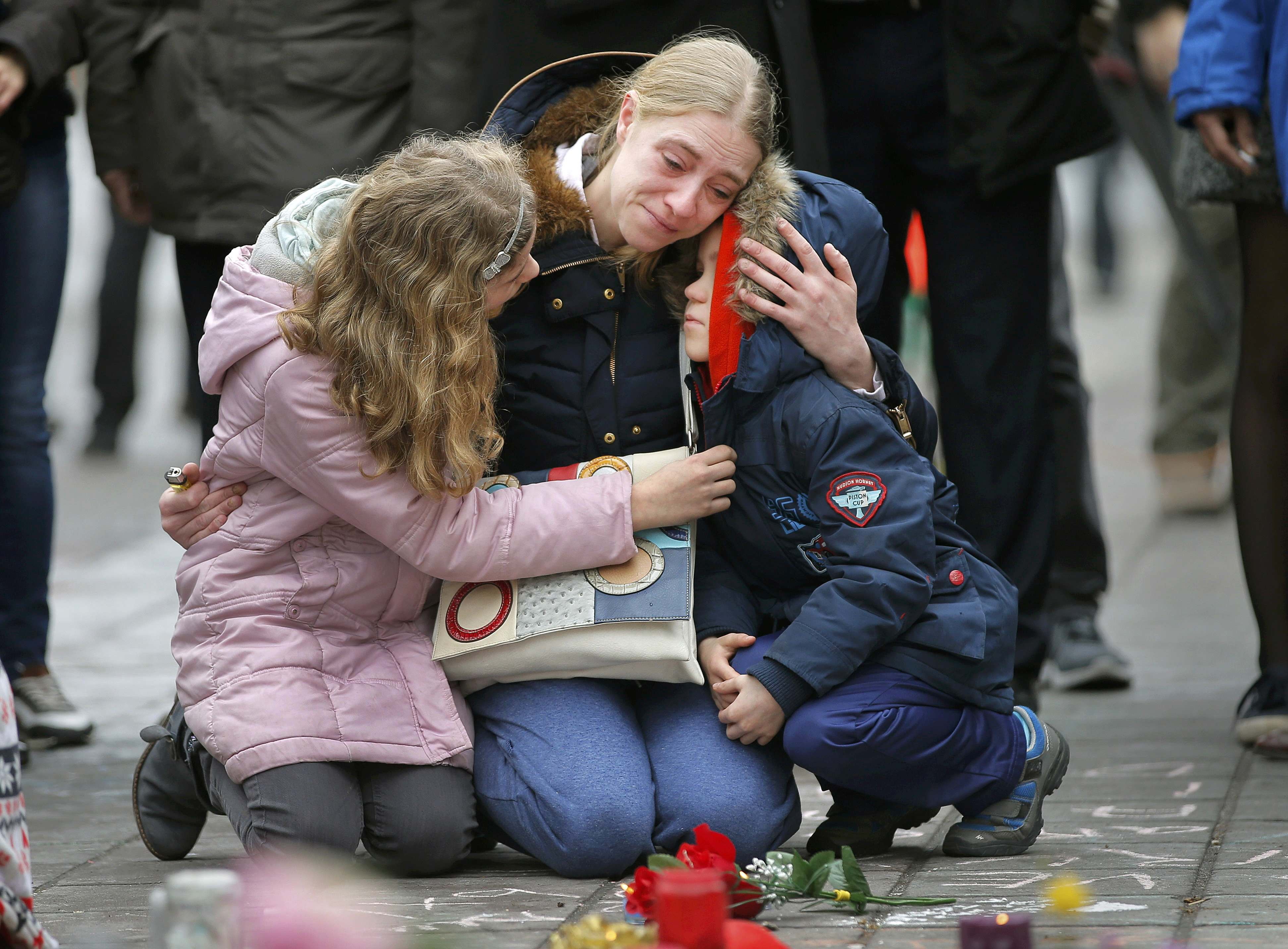 A woman consoles her children at a street memorial following Tuesday's bomb attacks in Brussels, on March 23, 2016. (Vincent Kessler—Reuters)