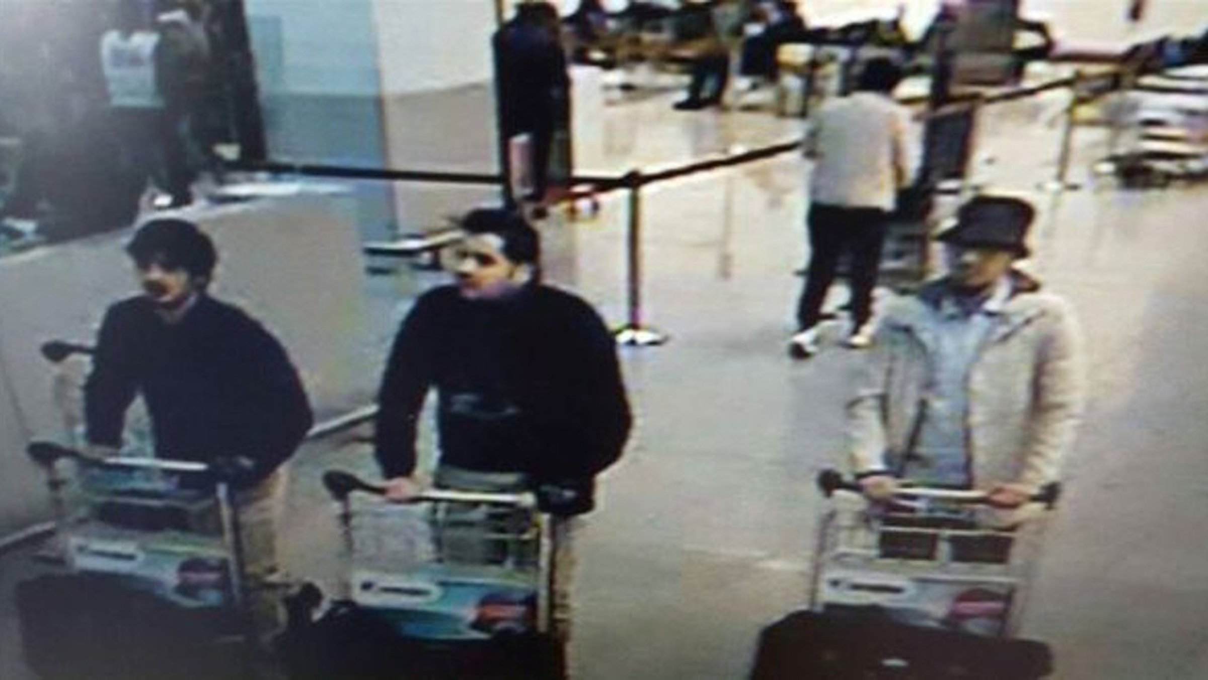 This image provided by the Belgian Federal Police in Brussels on Tuesday, March 22, 2016 shows men who are suspected of taking part in the attacks at Belgium's Zaventem Airport. The man at right is still being sought by the police and two others in the photo that the police issued were according to a the Belgian Prosecutors 'probably' suicide bombers.