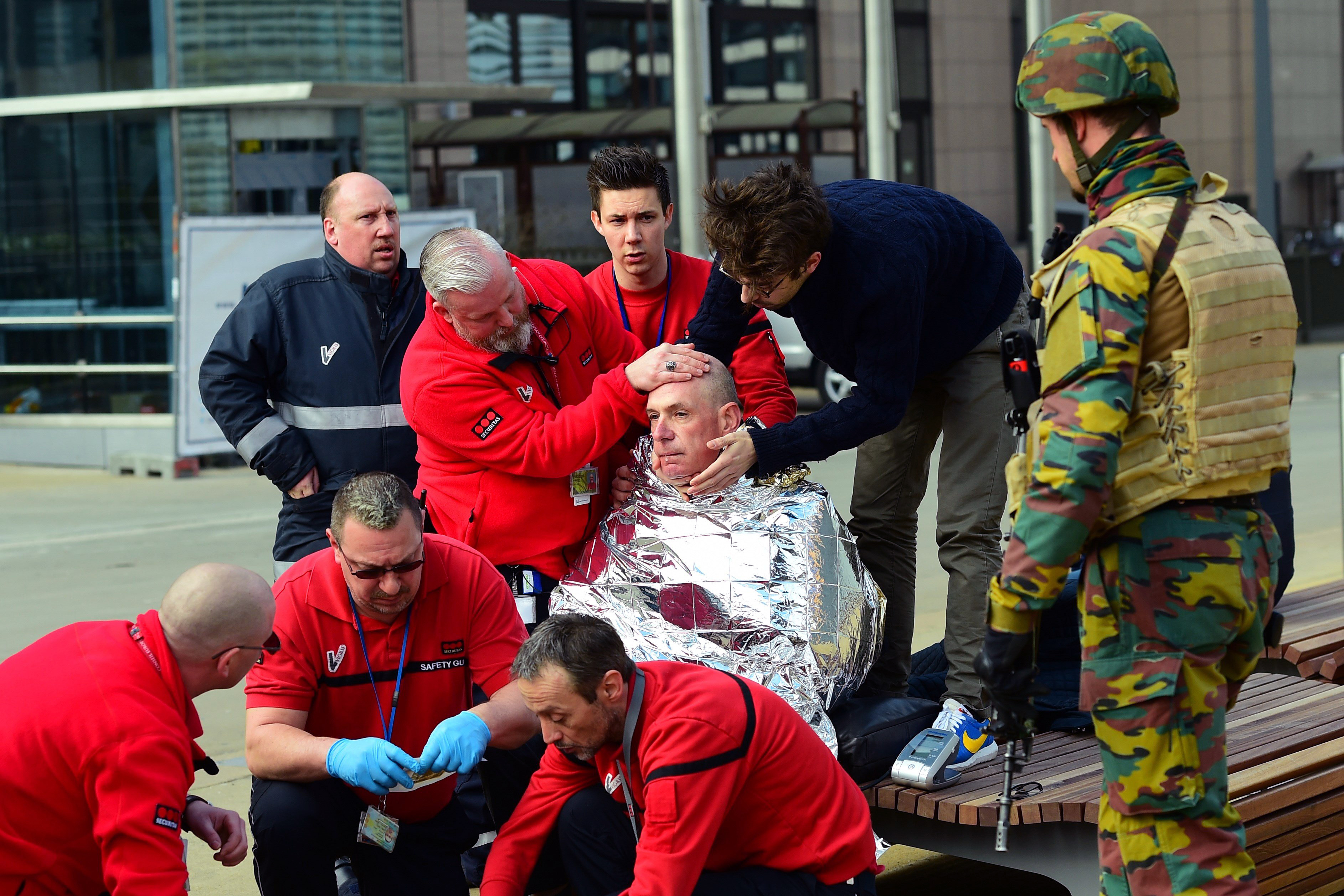 A victim receives first aid by rescuers, on March 22, 2016, near Maelbeek metro station in Brussels, after a blast at this station near the E.U. institutions caused deaths and injuries (Emmanuel Dunand—AFP/Getty Images)