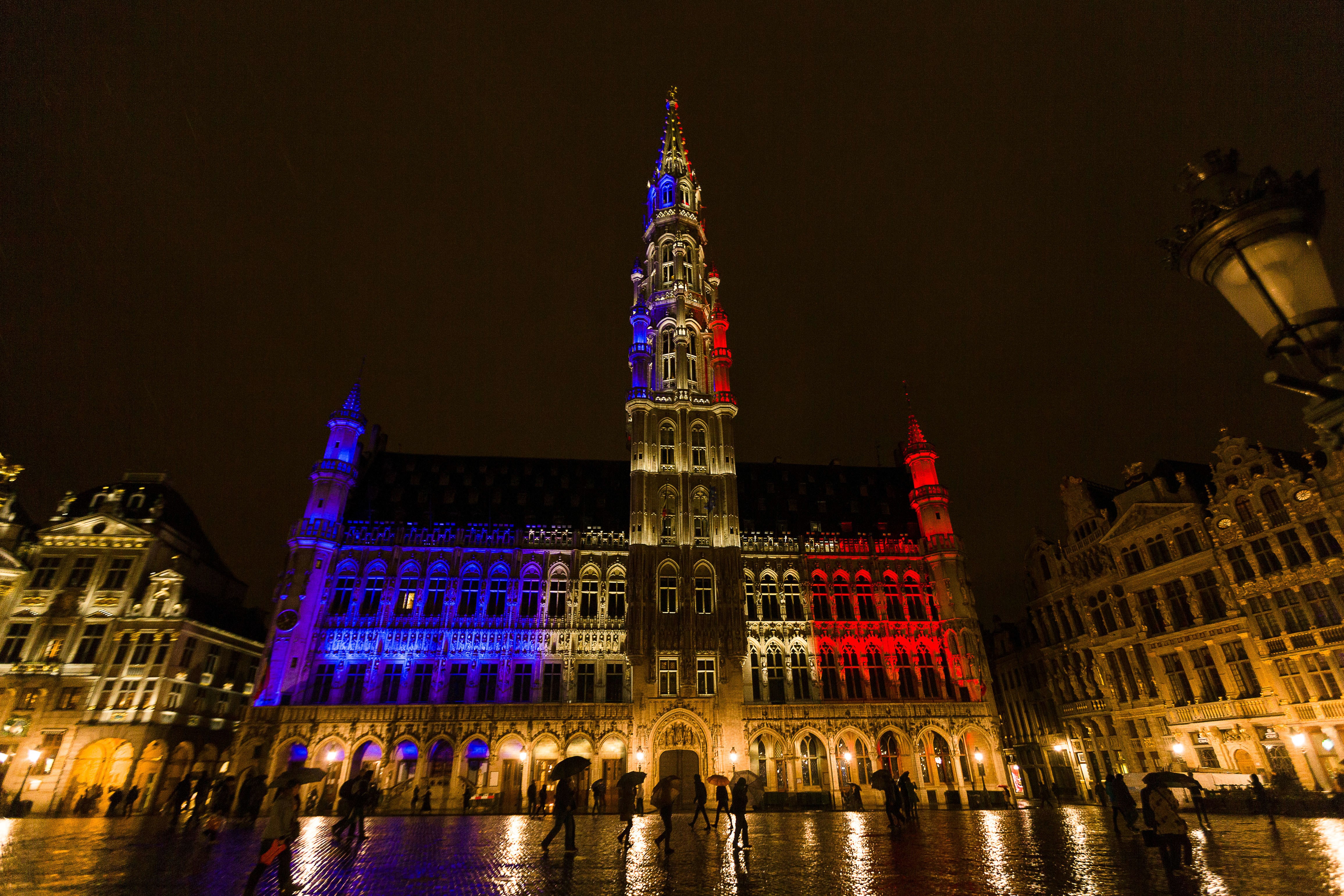 The town hall of Brussels is illuminated with the colors of the French national flag, at the Brussels Grand Place, on Nov. 14, 2015, a day after deadly attacks in Paris. (James Arthur Gekiere—AFP/Getty Images)