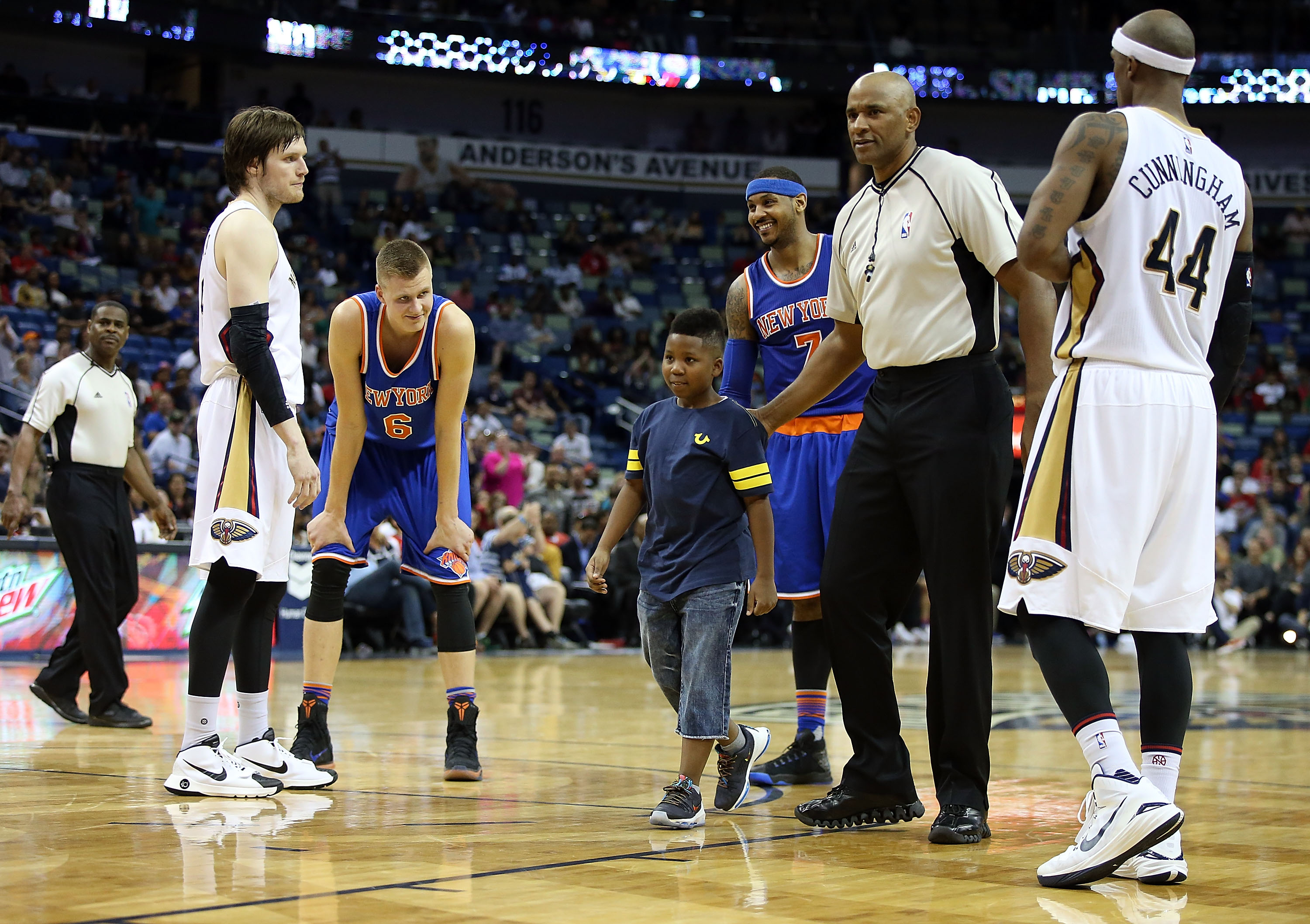 A young boy is escorted off the court after hugging Carmelo Anthony #7 of the New York Knicks during a game against the New Orleans Pelicans during the second half at the Smoothie King Center on March 28, 2016 in New Orleans, Louisiana. (Sean Gardner/Getty Images)