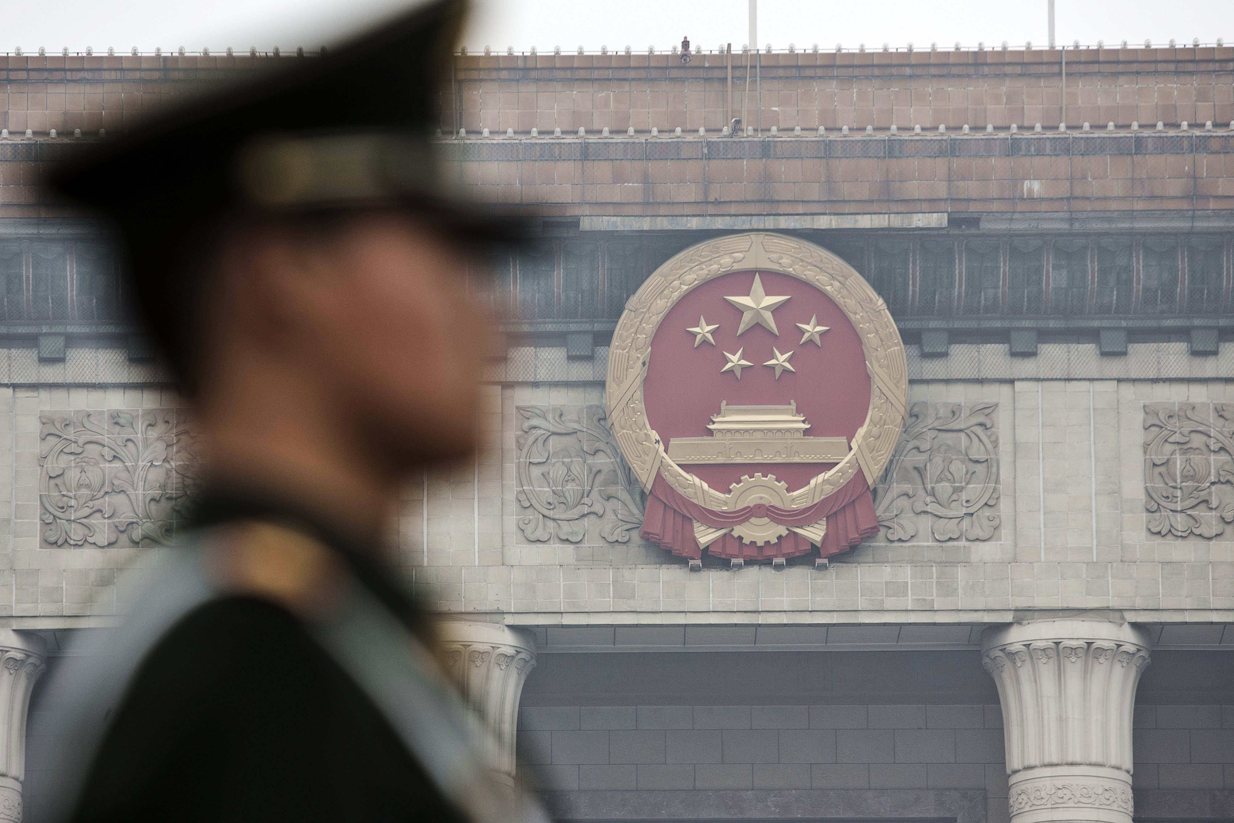 A paramilitary police officer stands guard in front of the Great Hall of the People in Beijing, China, on March 4, 2016. (Qilai Shen—Bloomberg via Getty Images)