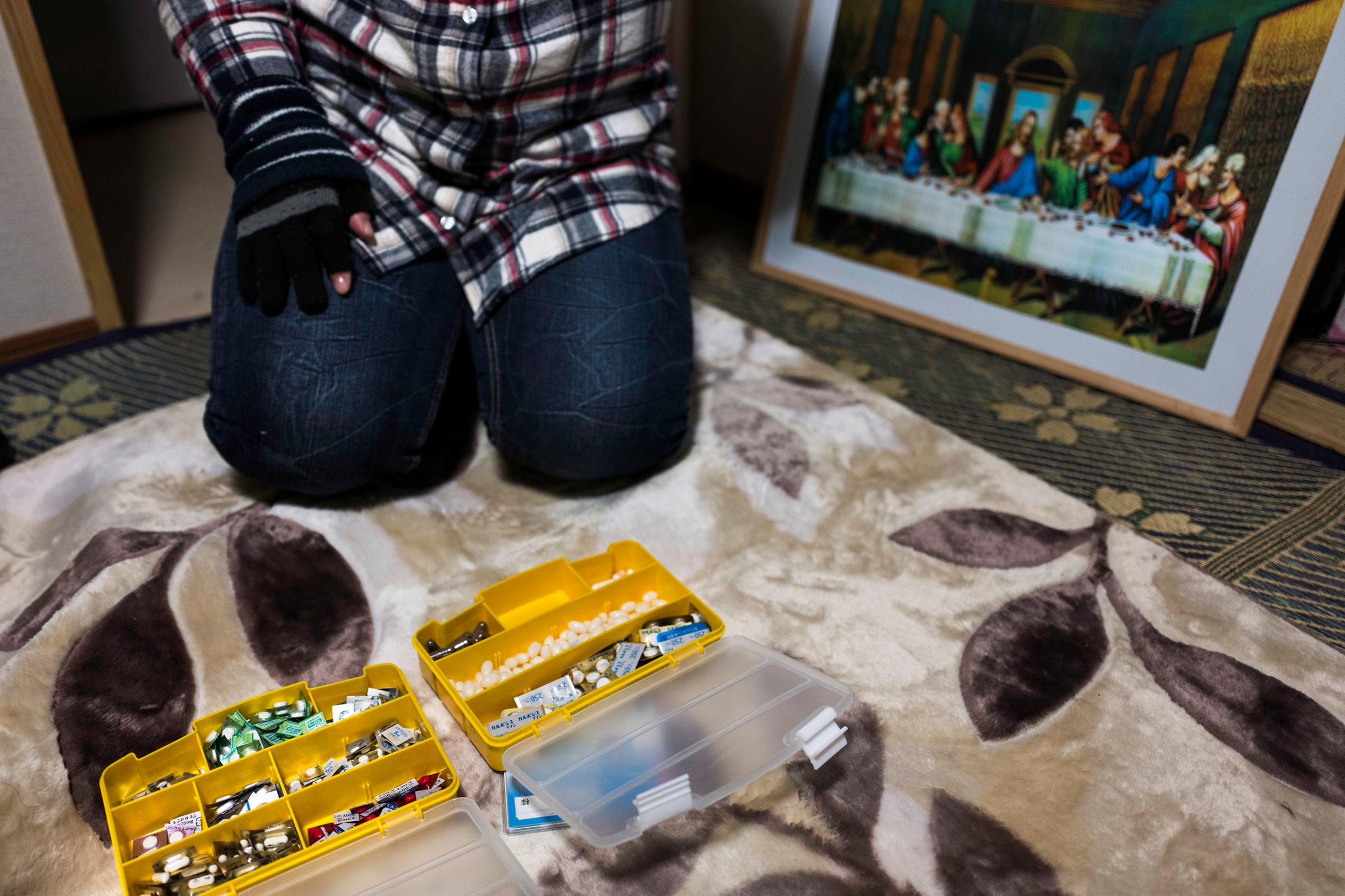 Terumi Murakami, a 43-year-old mother of three children and an evacuee from Okuma, 5km from the Fukushima Daiichi nuclear power plant, shows all the daily pills she takes, Iwaki, Japan, March 4, 2016. Murakami said severe depression and isolation pushed her to attempt suicide in this bedroom on April 5, 2015, after taking two month's worth of prescription drugs for depression. She survived after her children found her and called an ambulance. It was also the first day of school for her youngest daughter.