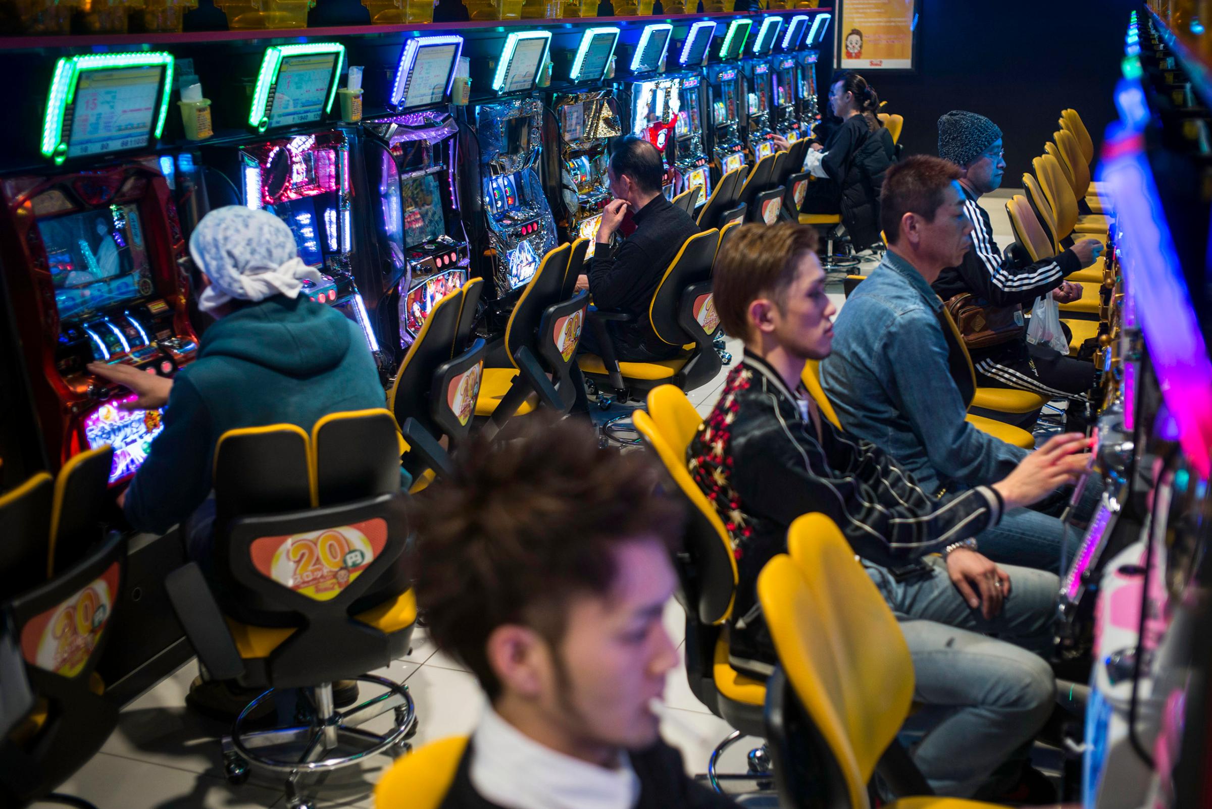 Yuki Mine, a 34-year-old part-time hairdresser and bartender, and other Minamisoma residents enjoy legal gambling in one of the many slot machine arcades, March 6, 2016. Several arcades have opened up in this region due to the high number of decontamination and other workers that have flocked to the town, as well as many residents who have received large amounts of compensation.
