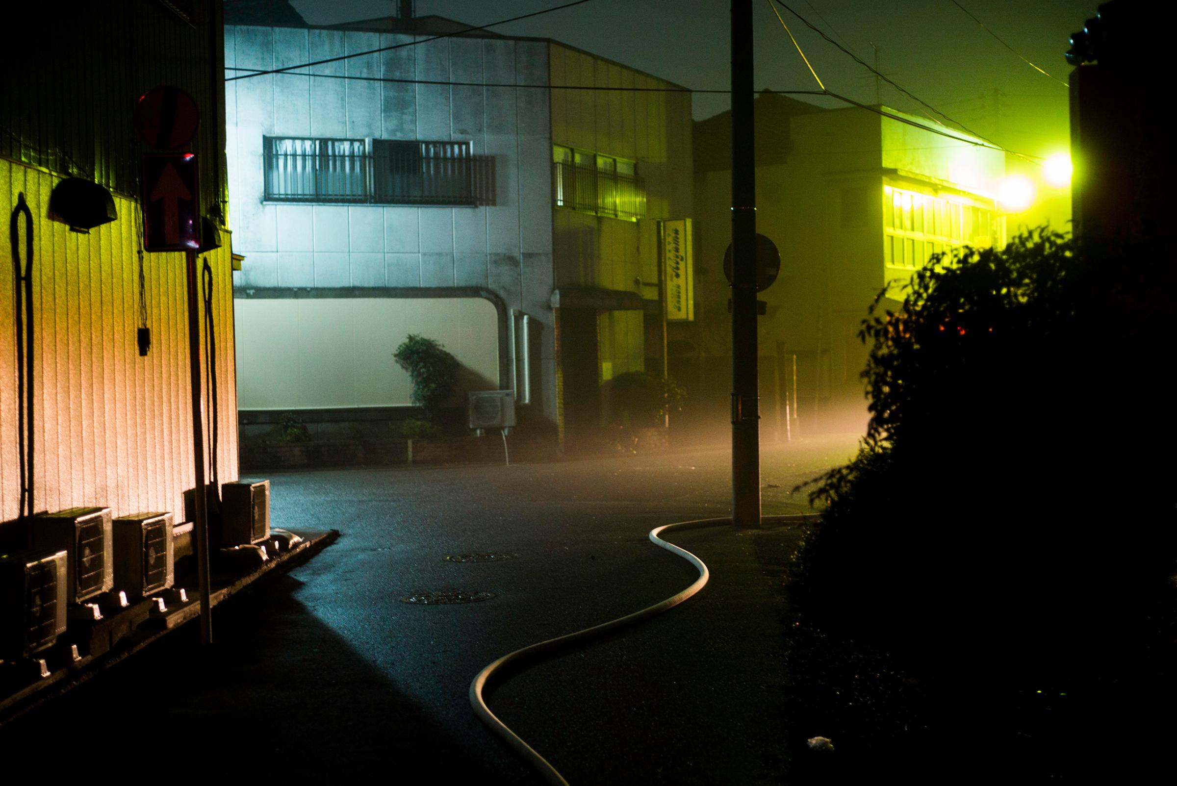 A hose from a fire engine is seen after an incident at a bar in Minamisoma, Fukushima, March 8, 2016.