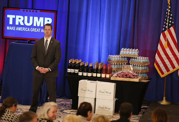 A security agent stands near a display of products that Republican presidential candidate Donald Trump has for guests, including meat, wine and water before a press conference at the Trump National Golf Club Jupiter on March 8, 2016 in Jupiter, Florida.