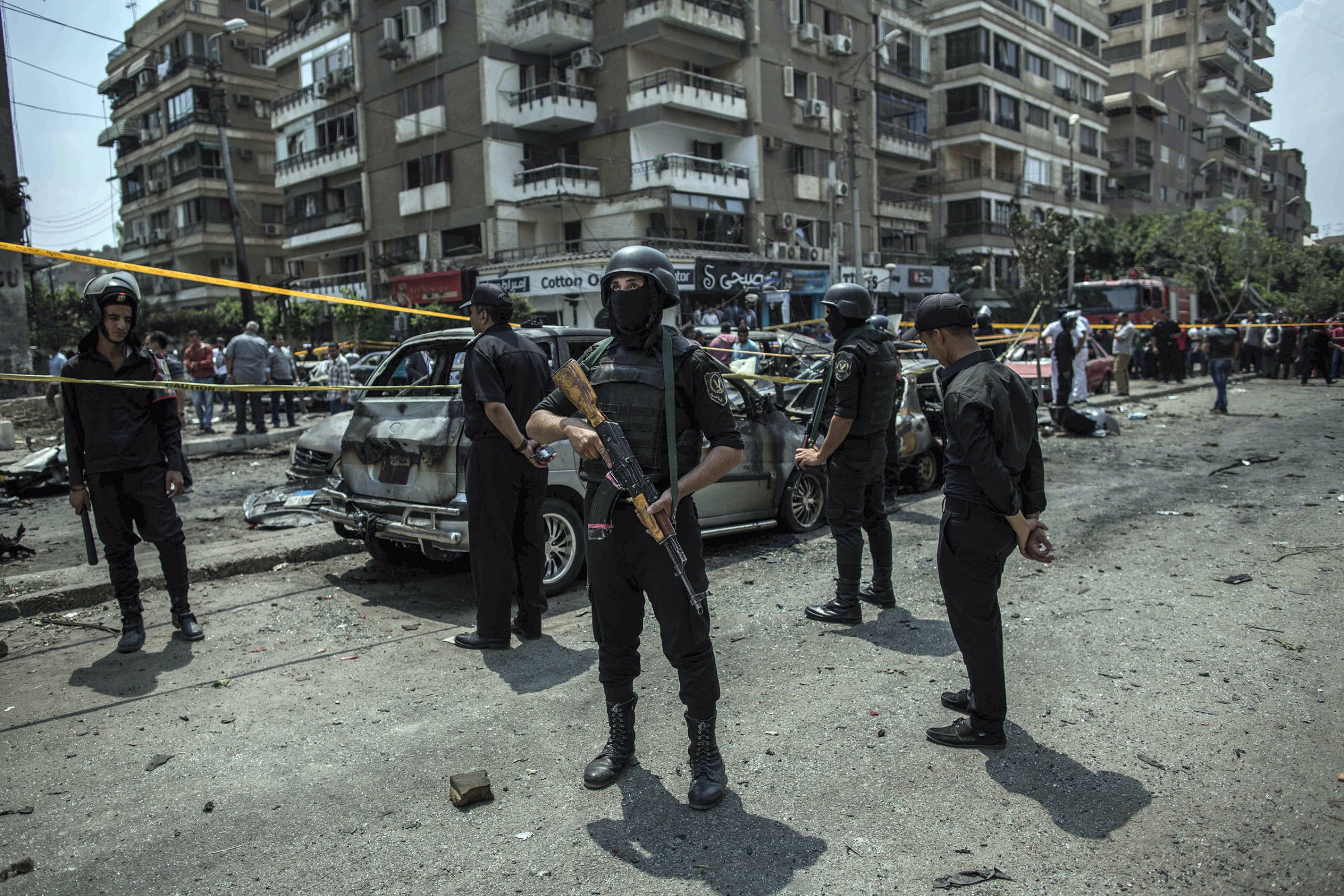 In this June 29, 2015, file photo, Egyptian policemen stand guard at the site of a bombing that killed Egypt's top prosecutor, Hisham Barakat, who oversaw cases against thousands of Islamists, in Cairo, Egypt.