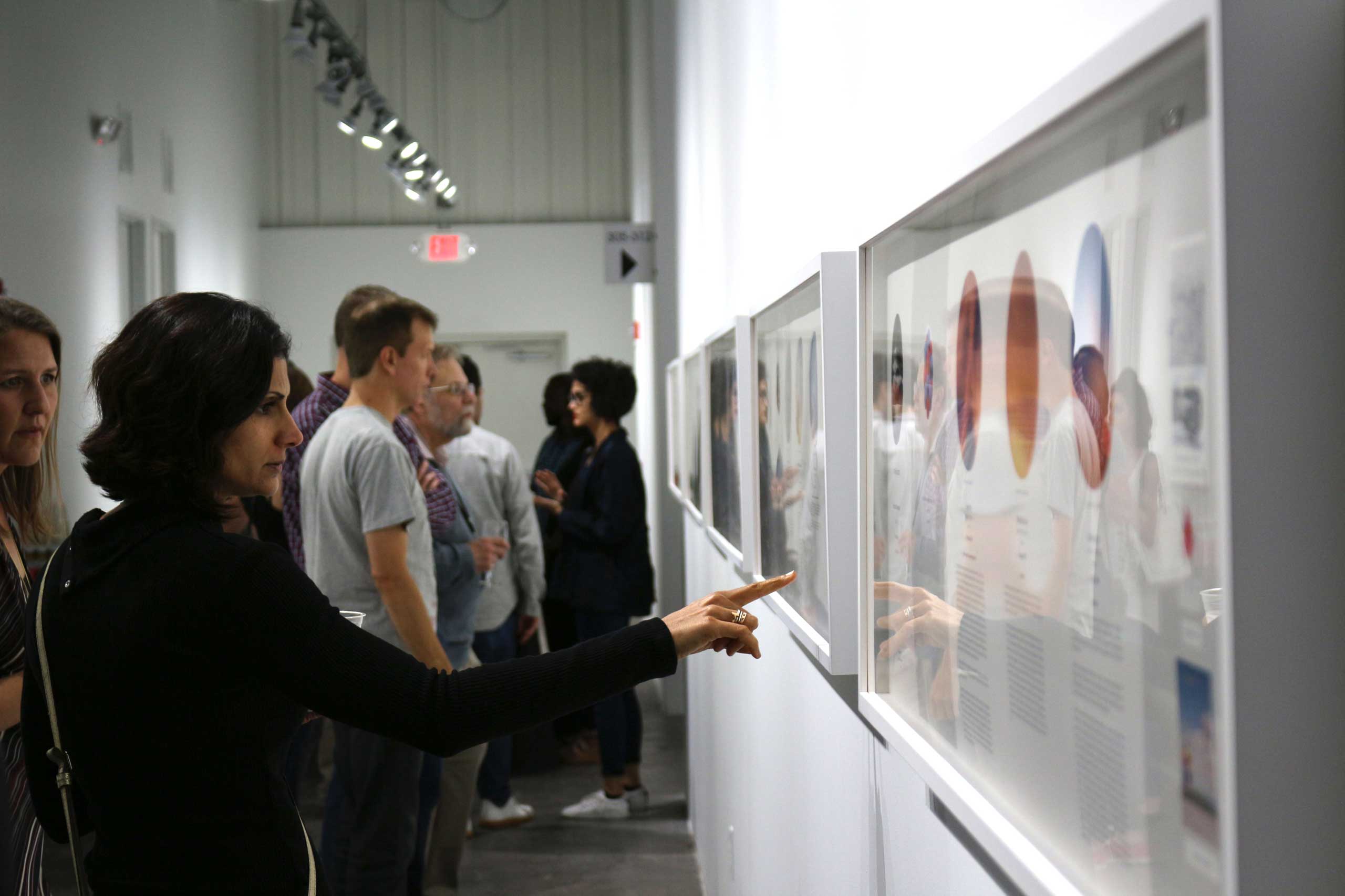 Attendees view work at FotoFest's Changing Circumstances exhibit. (Rachel Lowry for TIME)