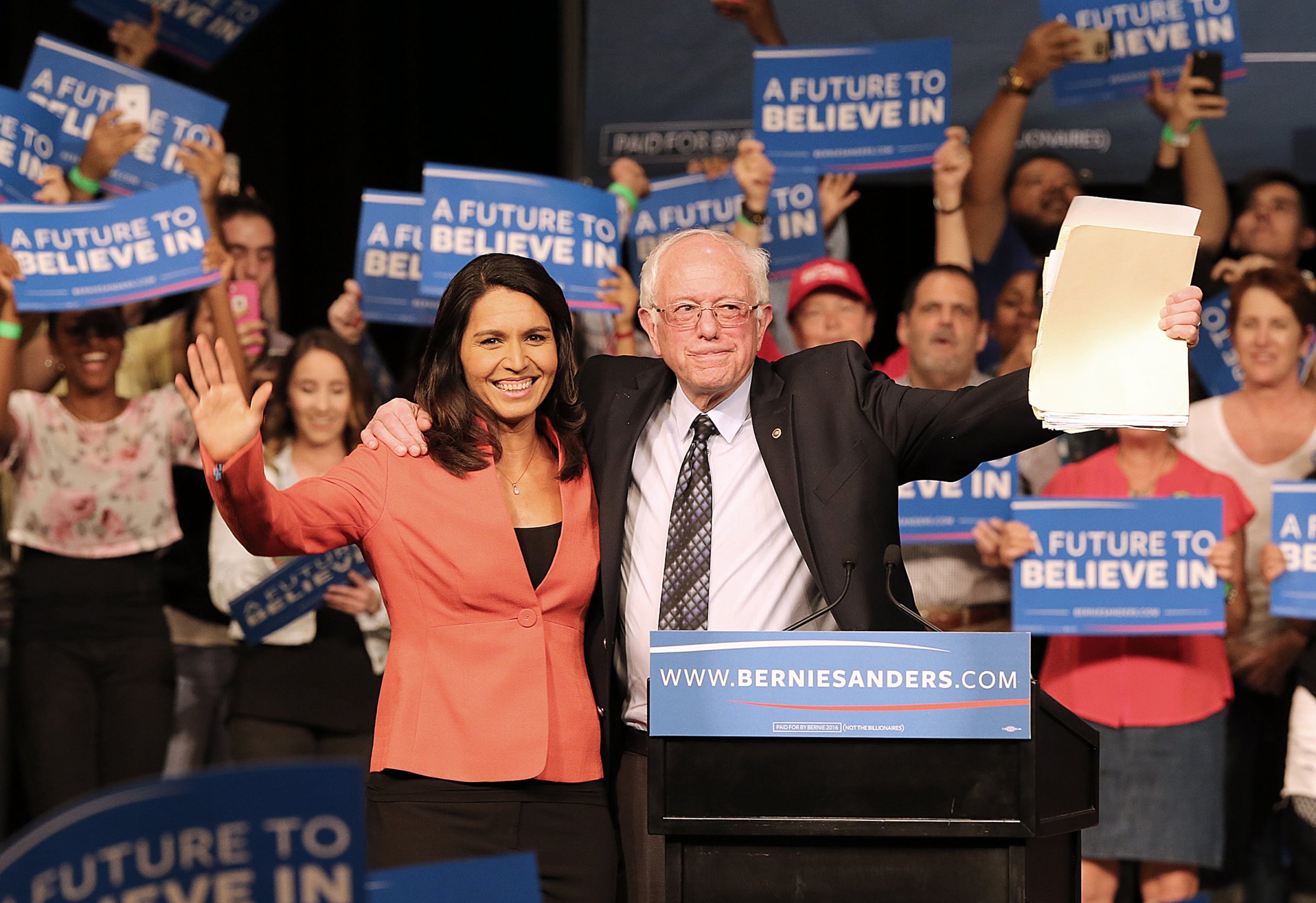 Rep. Tulsi Gabbard, D-Hawaii, and Democratic presidential candidate Sen. Bernie Sanders wave to supporters during a campaign event in Miami on Tuesday, March 8, 2016.