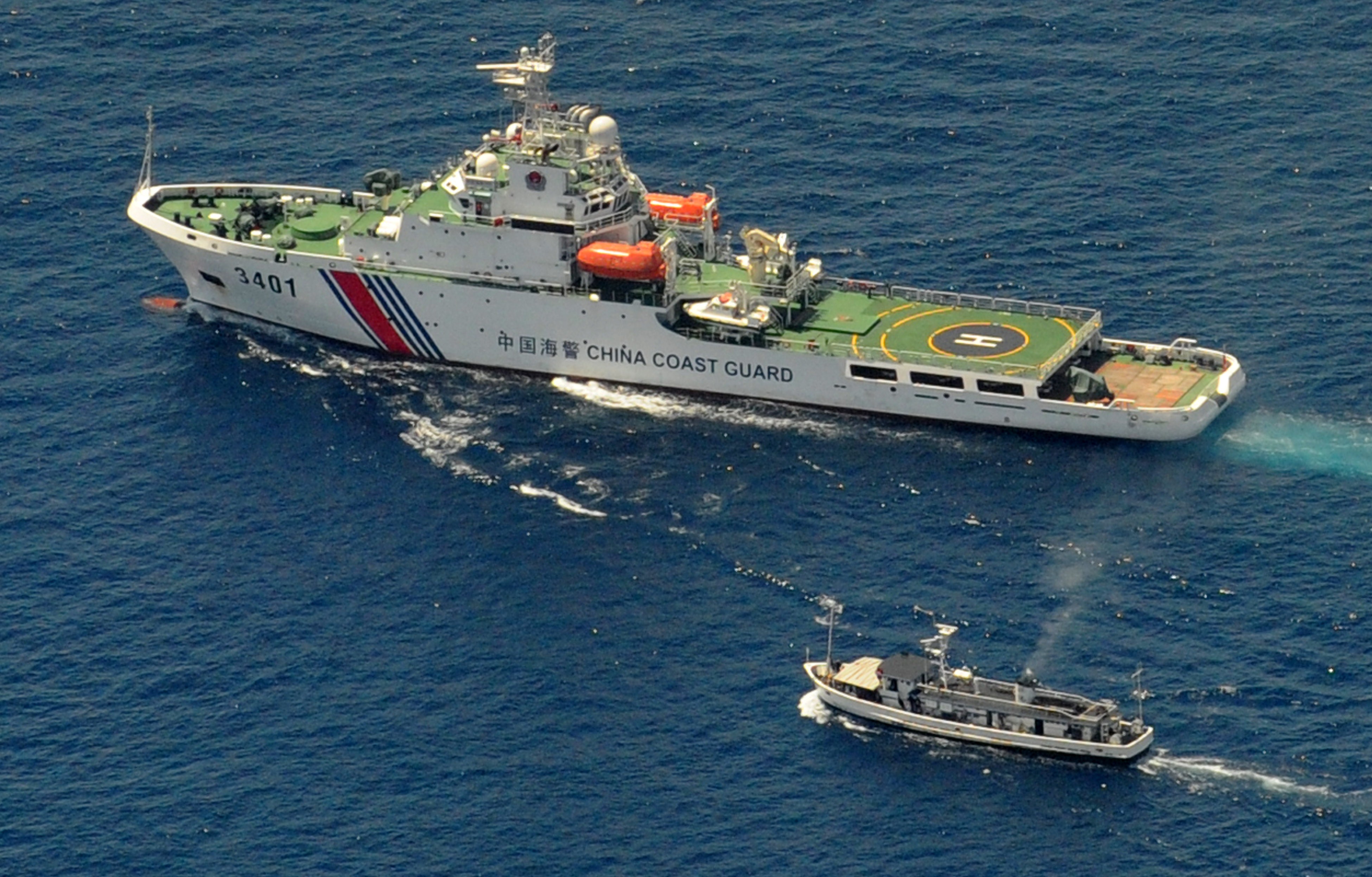 A China Coast Guard ship and a Philippine supply boat engage in a standoff as the Philippine boat attempts to reach the Second Thomas Shoal, a remote South China Sea reef claimed by both countries, on March 29, 2014 (Jay Directo—AFP/Getty Images)