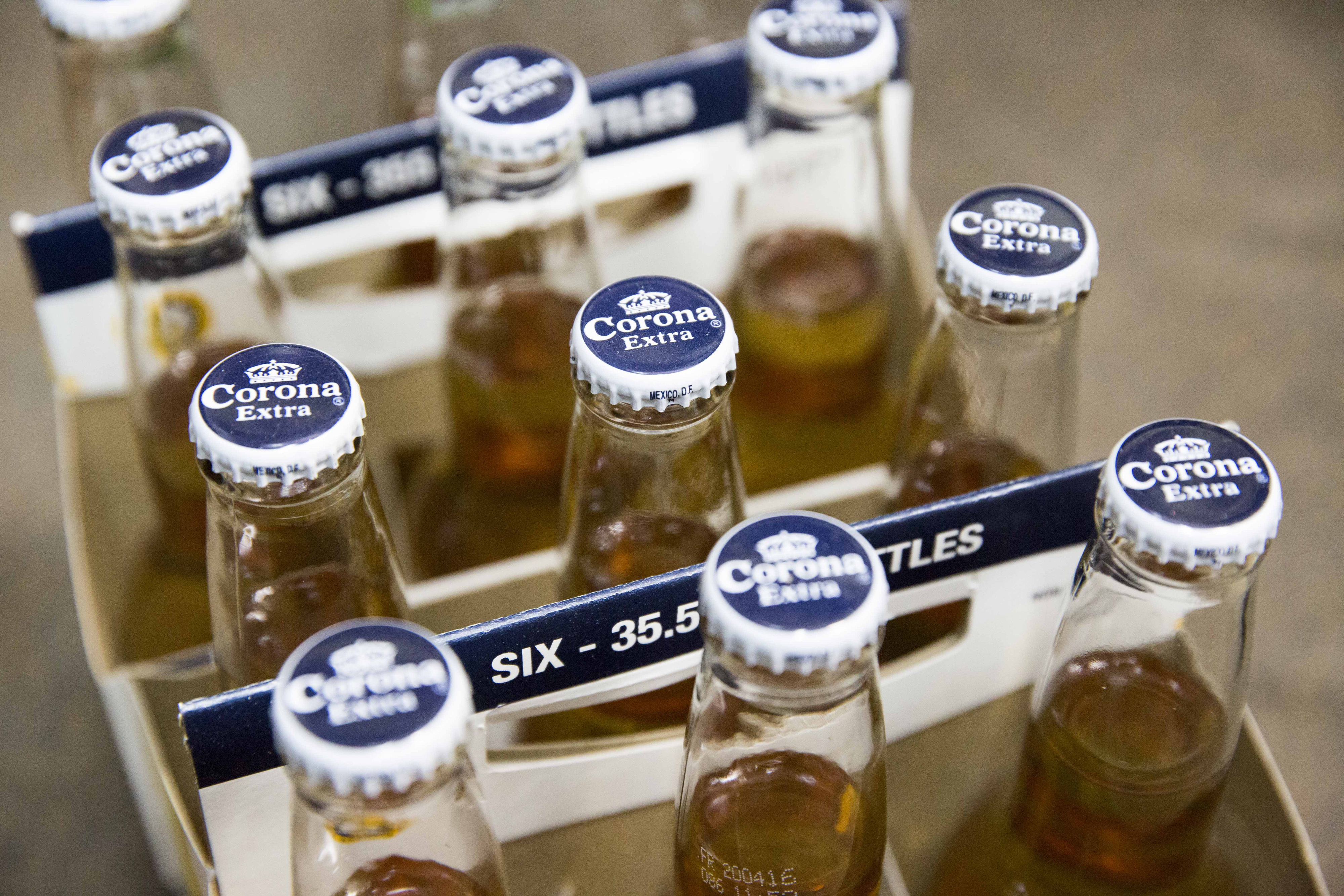 Six packs of bottled Corona beer, produced by Anheuser-Busch InBev NV, sit on display in a store in Paris, France, on Thursday, Oct. 15, 2015. AB Inbev is planning to sell bonds worth as much as $55 billion to finance its $106 billion takeover of SABMiller Plc, setting a record for debt issuance to fund a corporate acquisition, according to people familiar with the matter. (Bloomberg—Bloomberg via Getty Images)