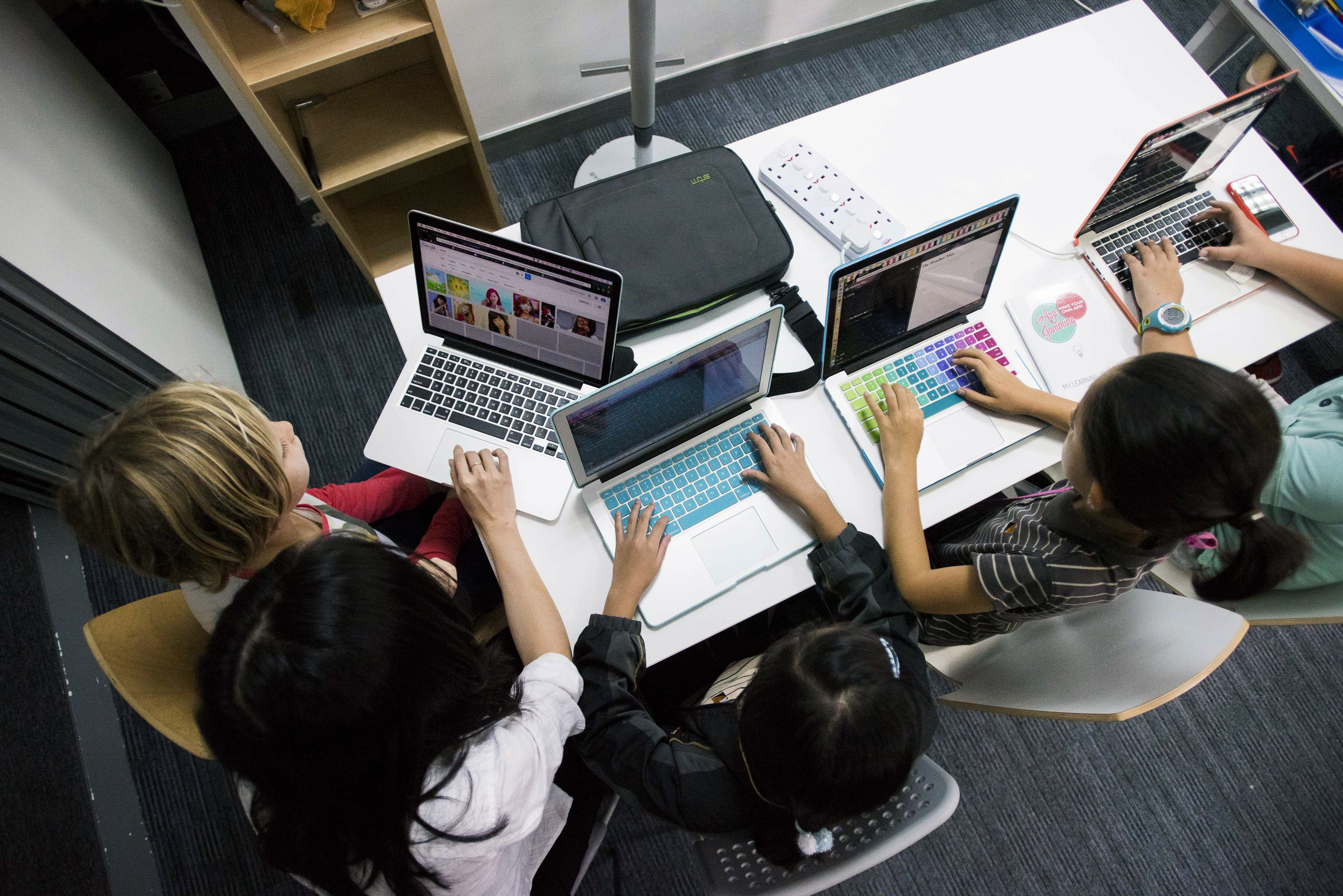 Students type on Apple Inc. laptop computers during a coding class at the First Code Academy in Hong Kong, China, on Friday, Nov. 13, 2015. About 2,500 students have taken courses at the First Code Academy. (Bloomberg—Bloomberg via Getty Images)