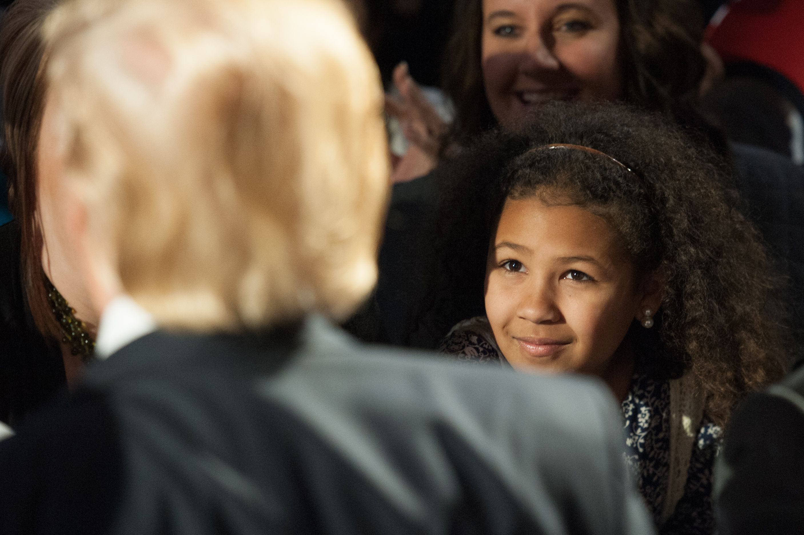 A young girl looks on as Republican Presidential candidate Donald Trump signs autographs at a rally  on Feb. 27,  in Millington, Tennesse. (MICHAEL B. THOMAS/AFP/Getty Images)