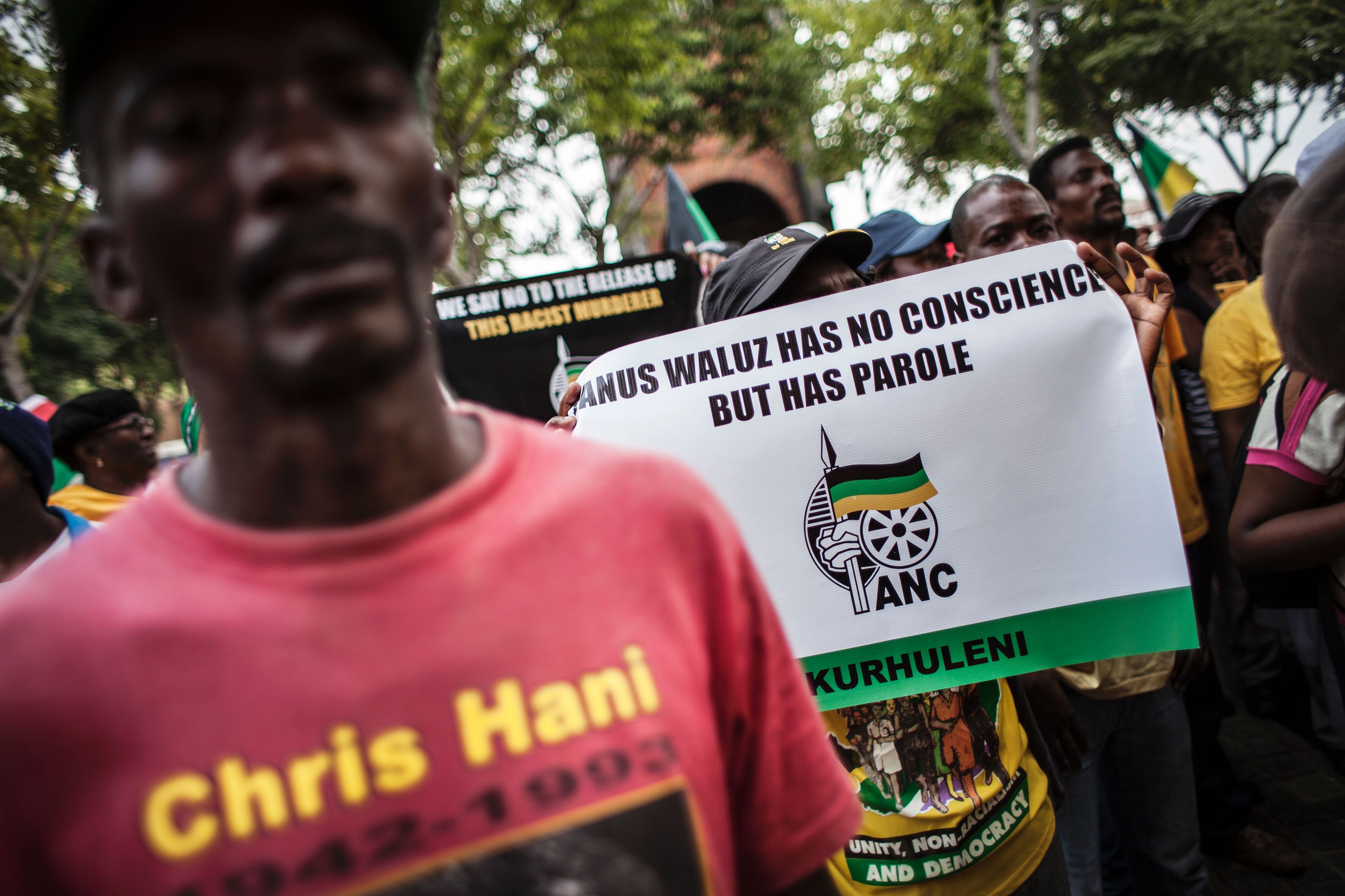 Members of the African National Congress demonstrate outside the Constitutional Court in protest over the parole granted to Janusz Walus, the killer of the anti-apartheid hero Chris Hani on March 14, 2016 (John Wessels—AFP/Getty Images)