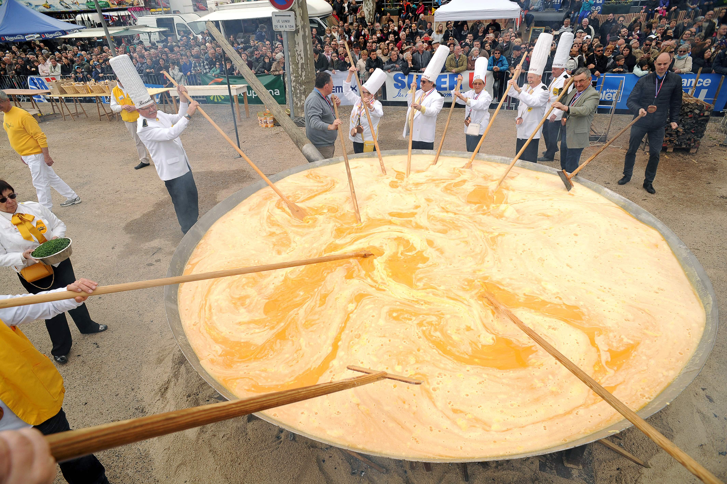 Members of the Giant Omelette Brotherhood of Bessieres cook a giant omelette as part of Easter celebrations in the main square of Bessieres, southern France on March 28, 2016. (Remy Gabalda—AFP/Getty Images)