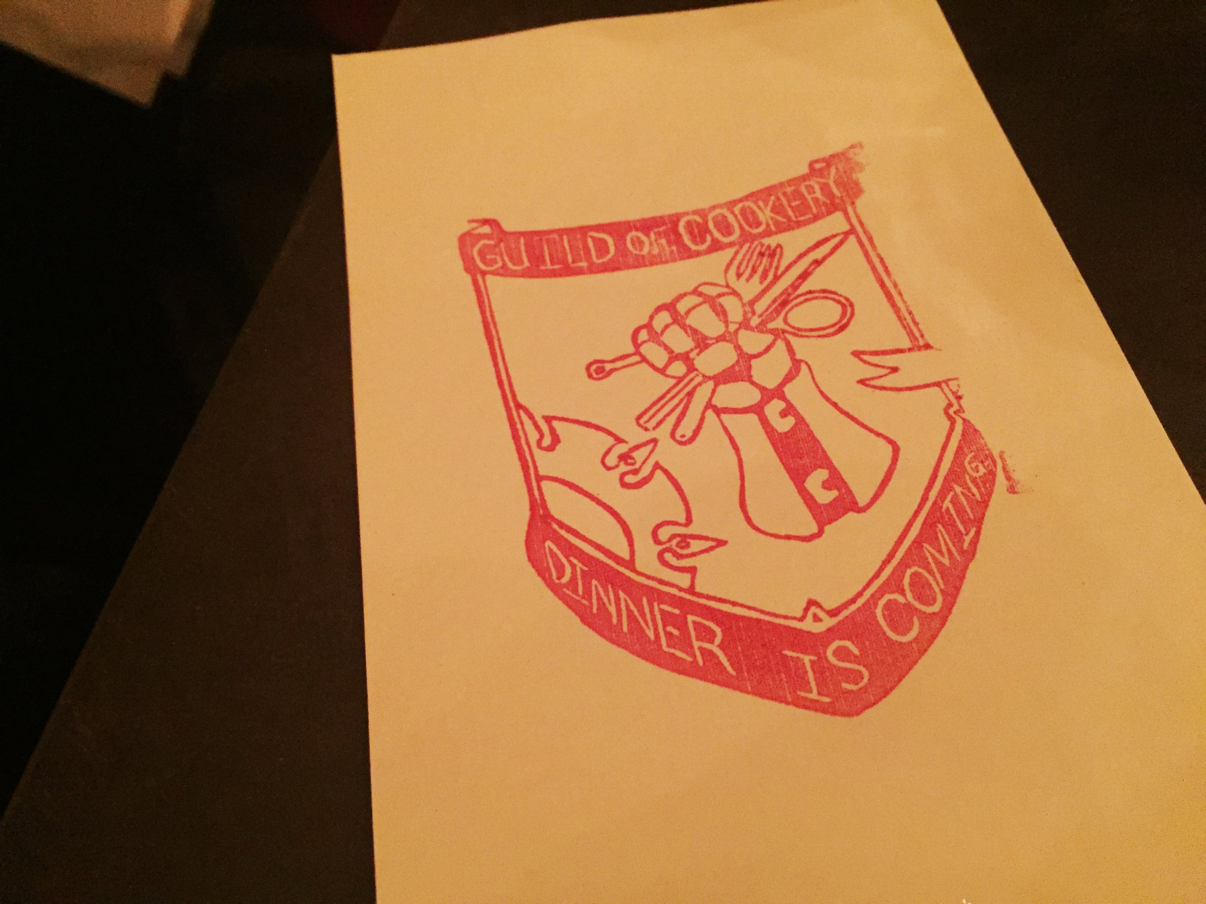 The Guild of Cookery decorates banners and menus with their sigil and house motto.