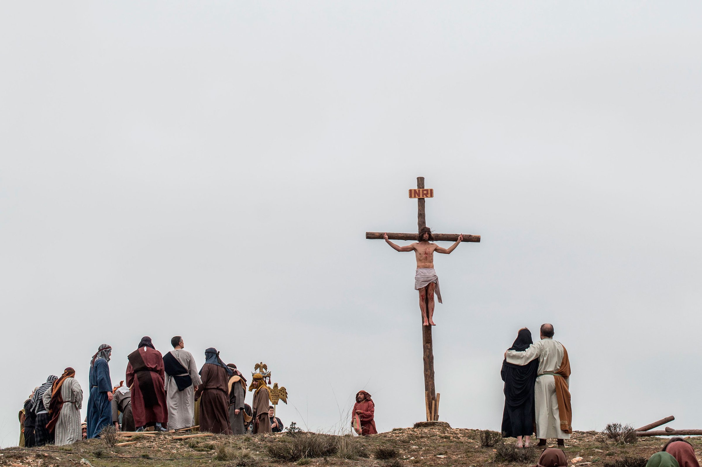 An actor portraying Jesus is crucified as residents dressed in period clothing perform during the reenactment of Christ's suffering, Hiendelaencia, Spain, March 25, 2016.