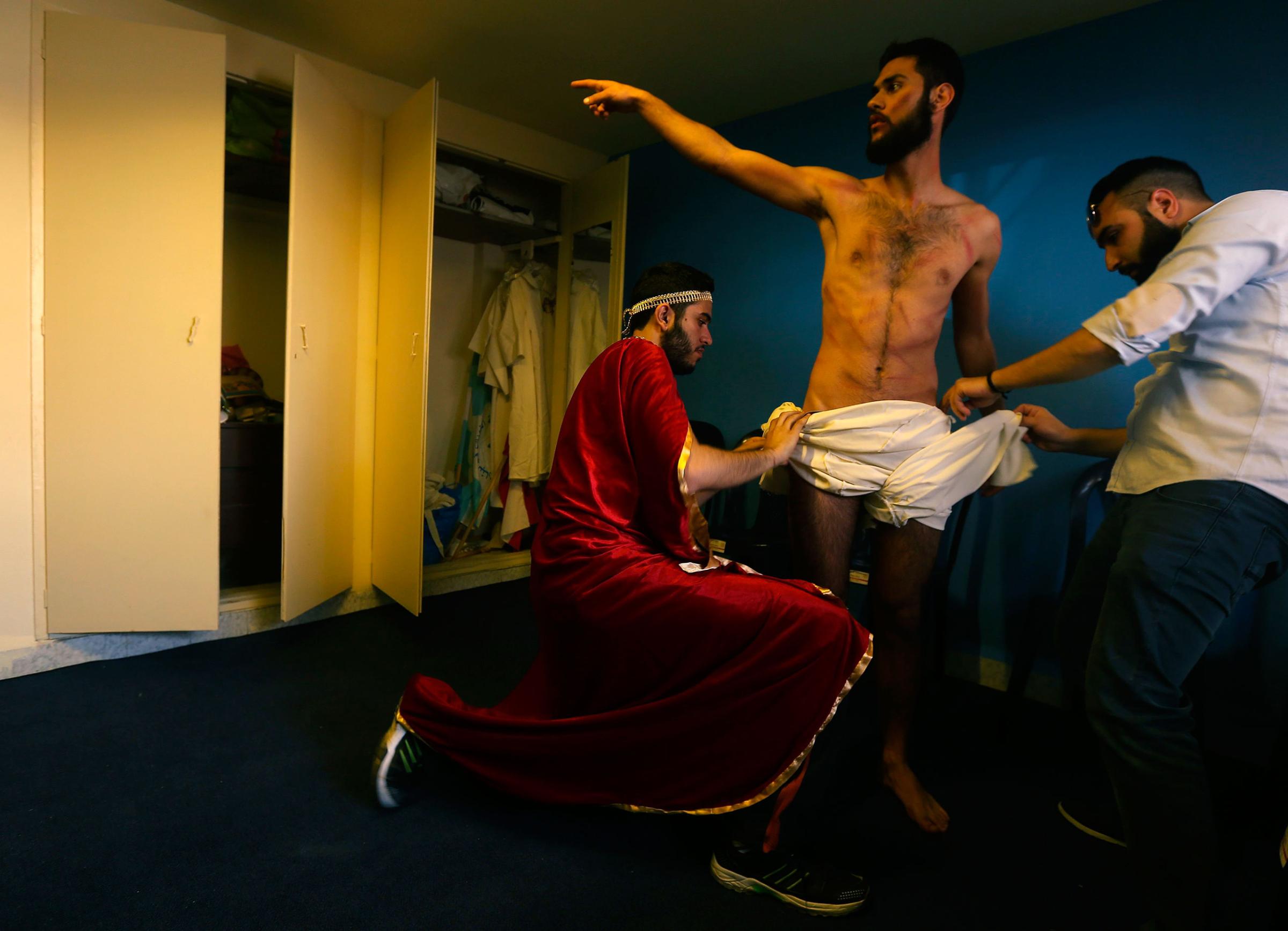 Lebanese Christians prepare the character playing Jesus as they reenact the crucifixion of Christ during Holy Friday in the Christian village of Qraiye, east of Sidon, Lebanon, March 25, 2016.