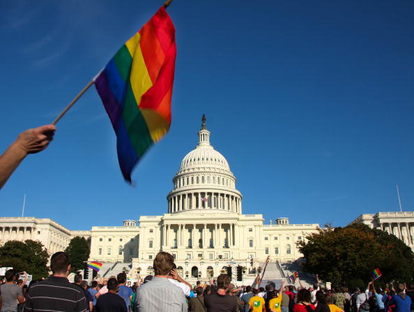 A demonstrator waves a rainbow flag in front of the US Capitol in Washington on October 11, 2009 as tens of thousands of gay activists marched to demand civil rights, a day after President Barack Obama vowed to repeal a ban on gays serving openly in the US military.