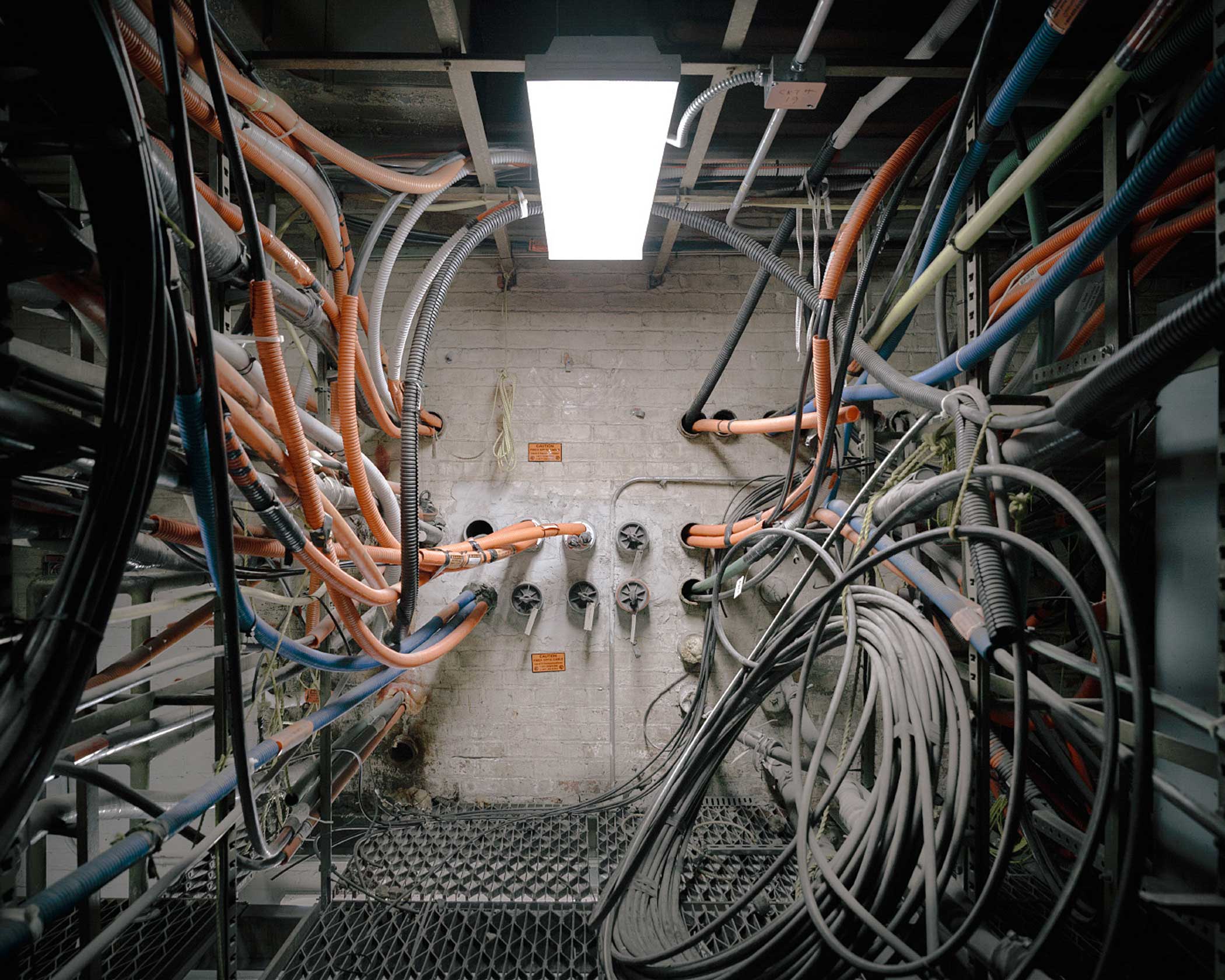 Fiber optic cables enter and exit carrier hotels through underground vaults. Some of these cables run local connections, others are on their way to eventually cross the Atlantic via landing stations in New York and New Jersey. Various networks and service providers pay for access to carrier hotels through the the conduit in these fiber vaults.