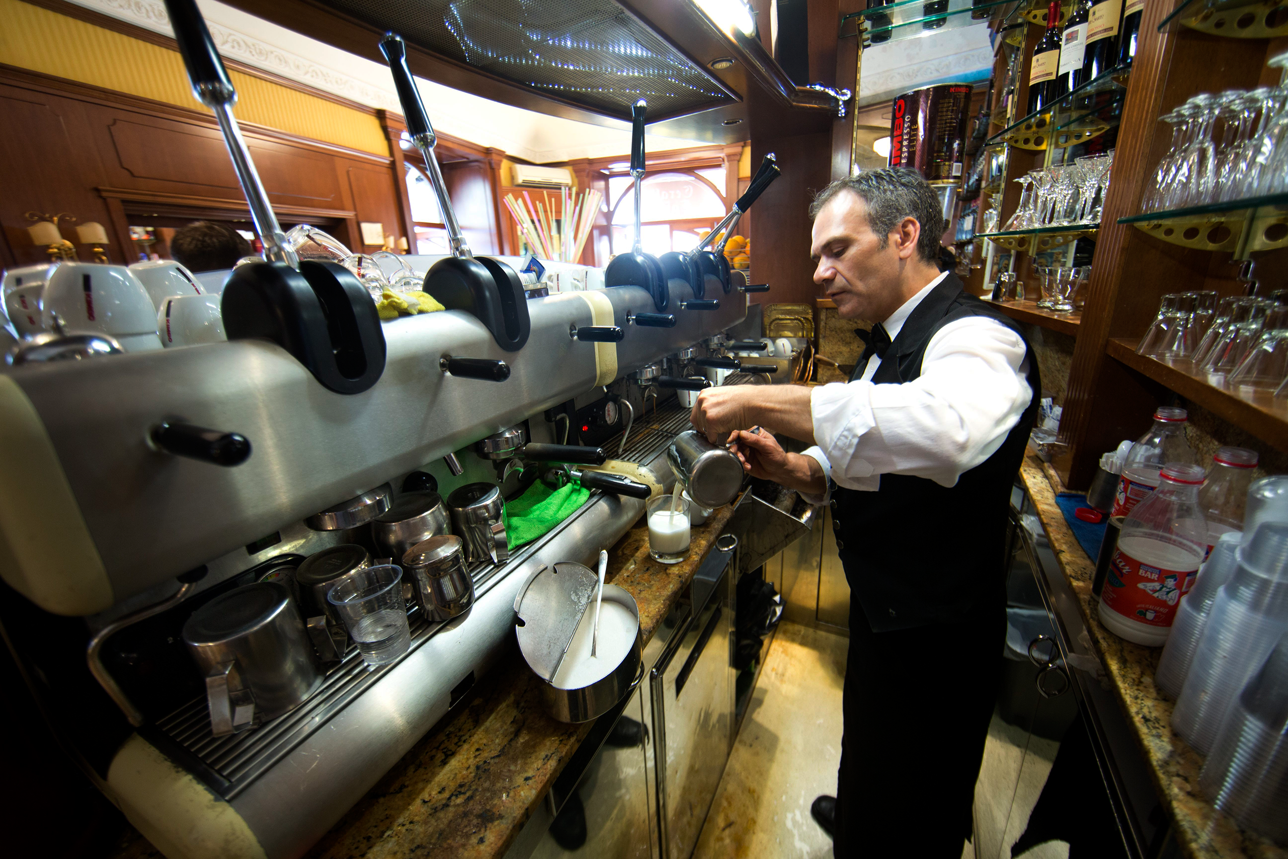 A senior coffee maker at Garaldi Caffe, located at Piazza Garita in Naples, Italy, Oct. 1, 2014. (Ton Koene—picture-alliance/dpa/AP)