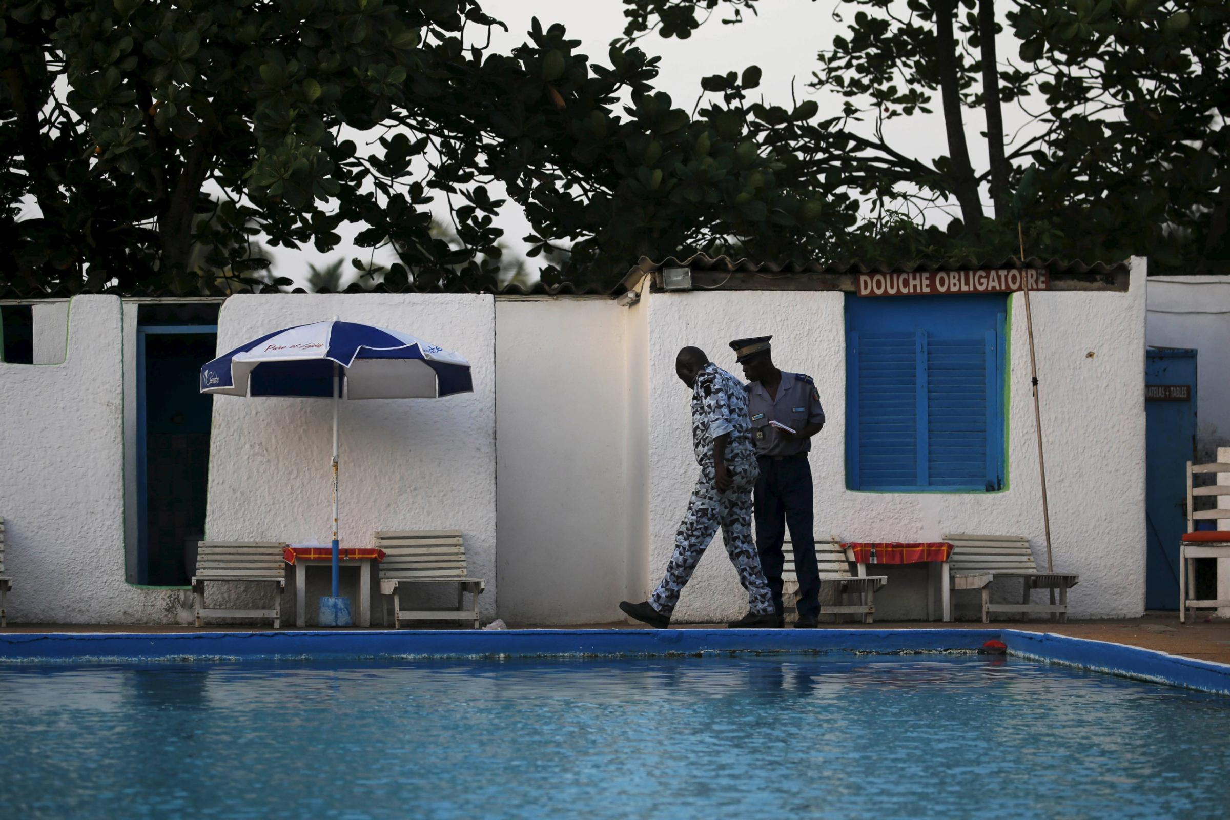 Security officers examine a hotel after an attack in Grand Bassam, Ivory Coast, March 13, 2016. REUTERS/Joe Penney