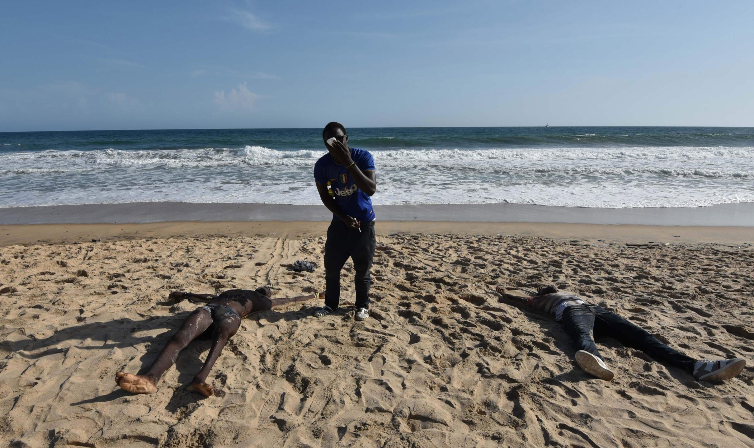 EDITORS NOTE: Graphic content / Bodies are seen on a beach after heavily armed gunmen opened fire on March 13, 2016 at a hotel in the Ivory Coast beach resort of Grand-Bassam. At least five people were killed on march 13 when heavily-armed gunmen opened fire in the Ivory Coast resort town of Grand-Bassam, leaving bodies strewn on the beach. "At the moment there are five dead," a military source said on condition of anonymity after the assault in the resort popular with Westerners. / AFP PHOTO / SIA-KAMBOUSIA-KAMBOU/AFP/Getty Images