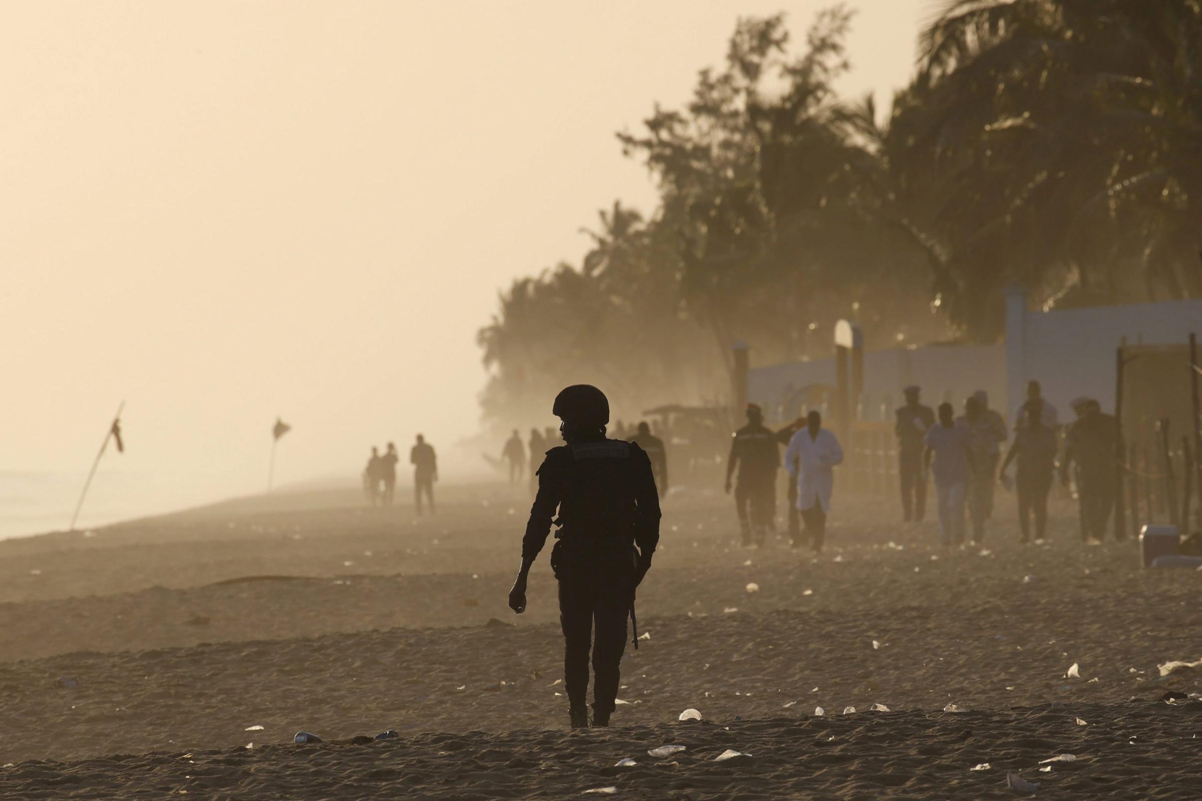 A security officer walks on the beach after an attack in Grand Bassam, Ivory Coast, March 13, 2016. REUTERS/Joe Penney
