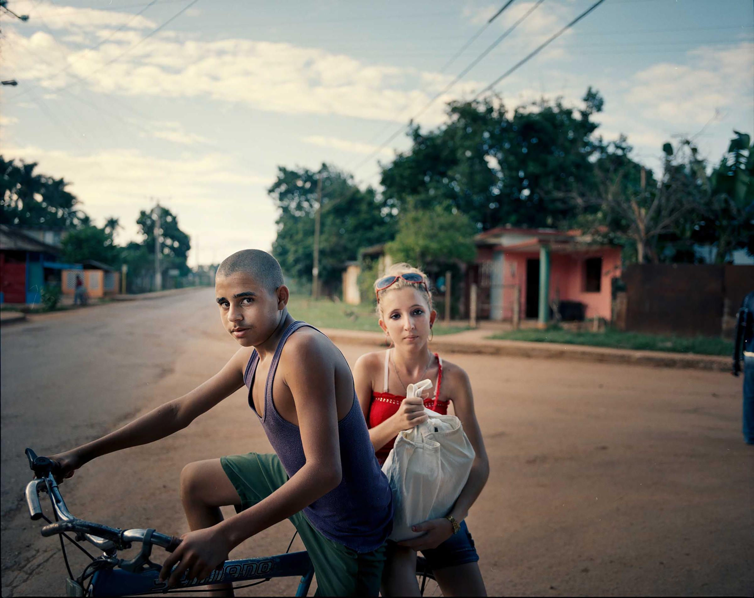 A young  couple run errands on a bike in Artemisa province, south of Havana, Cuba.
