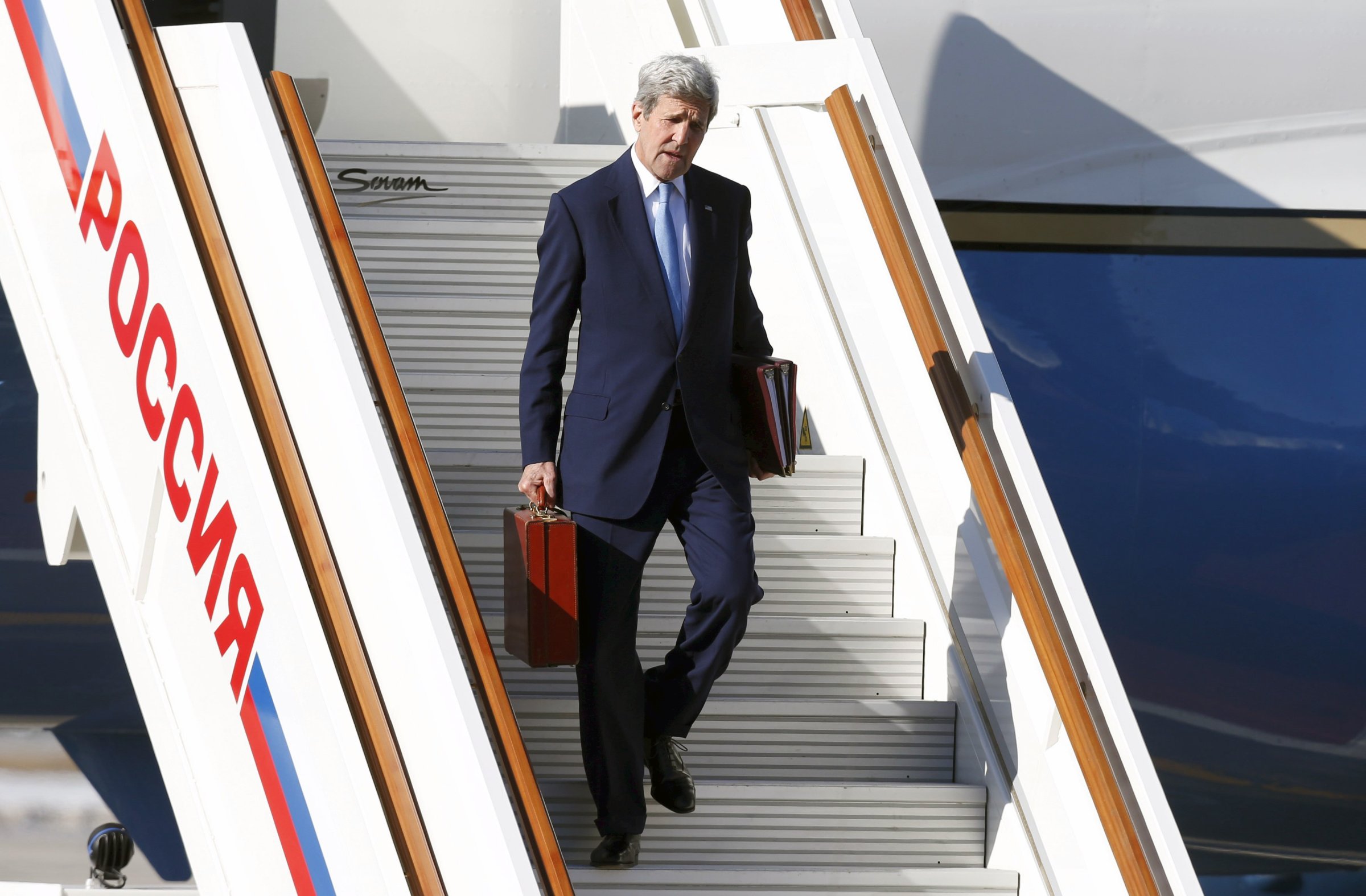 U.S. Secretary of State John Kerry carries his briefcase as he arrives at Moscow's Vnukovo airport in Russia, on March 23, 2016.