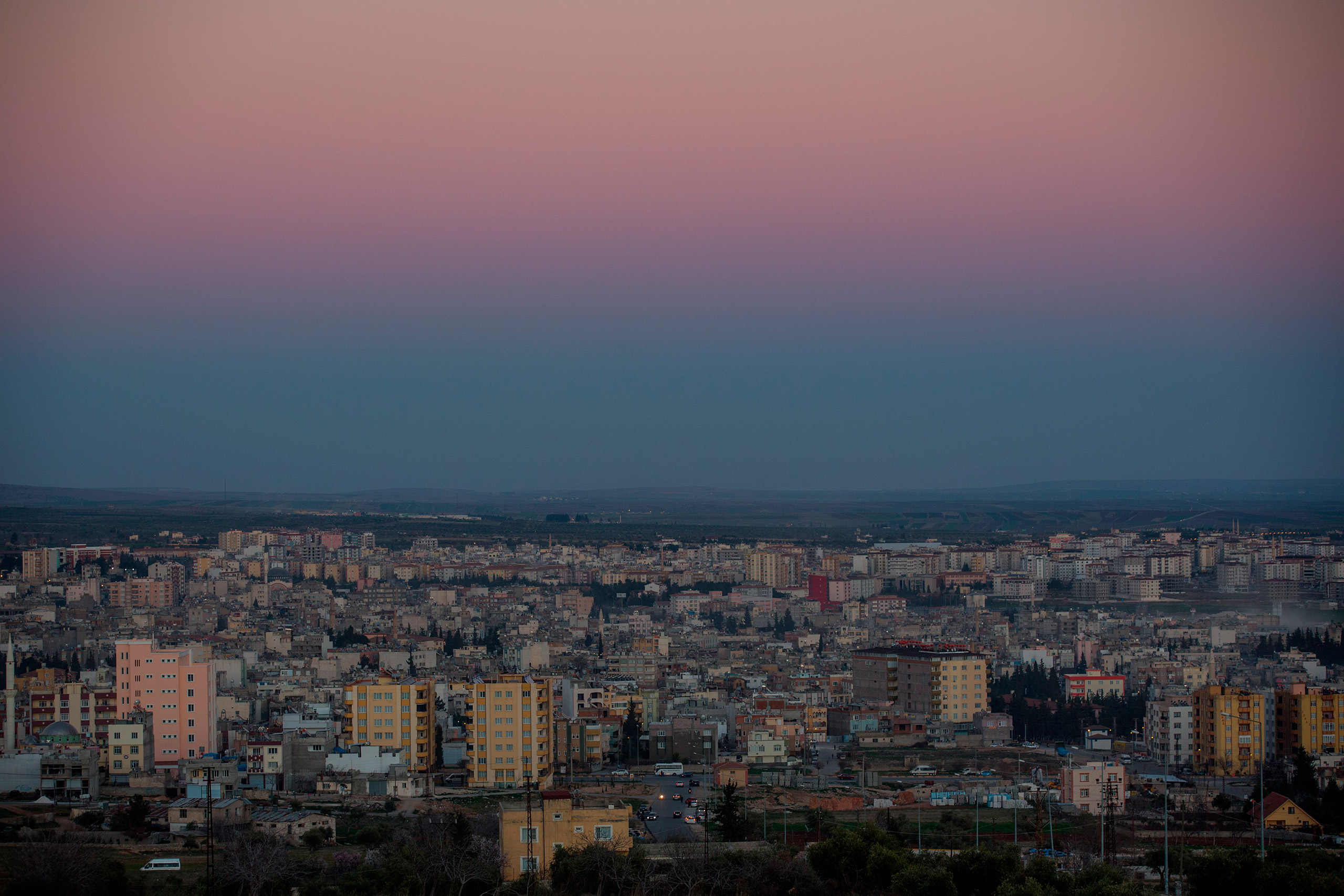 The sun sets on the city of Kilis, which lies along Turkey's southern border with Syria and includes the Oncupinar Crossing, March 1, 2016. (Chris McGrath—Getty Images)