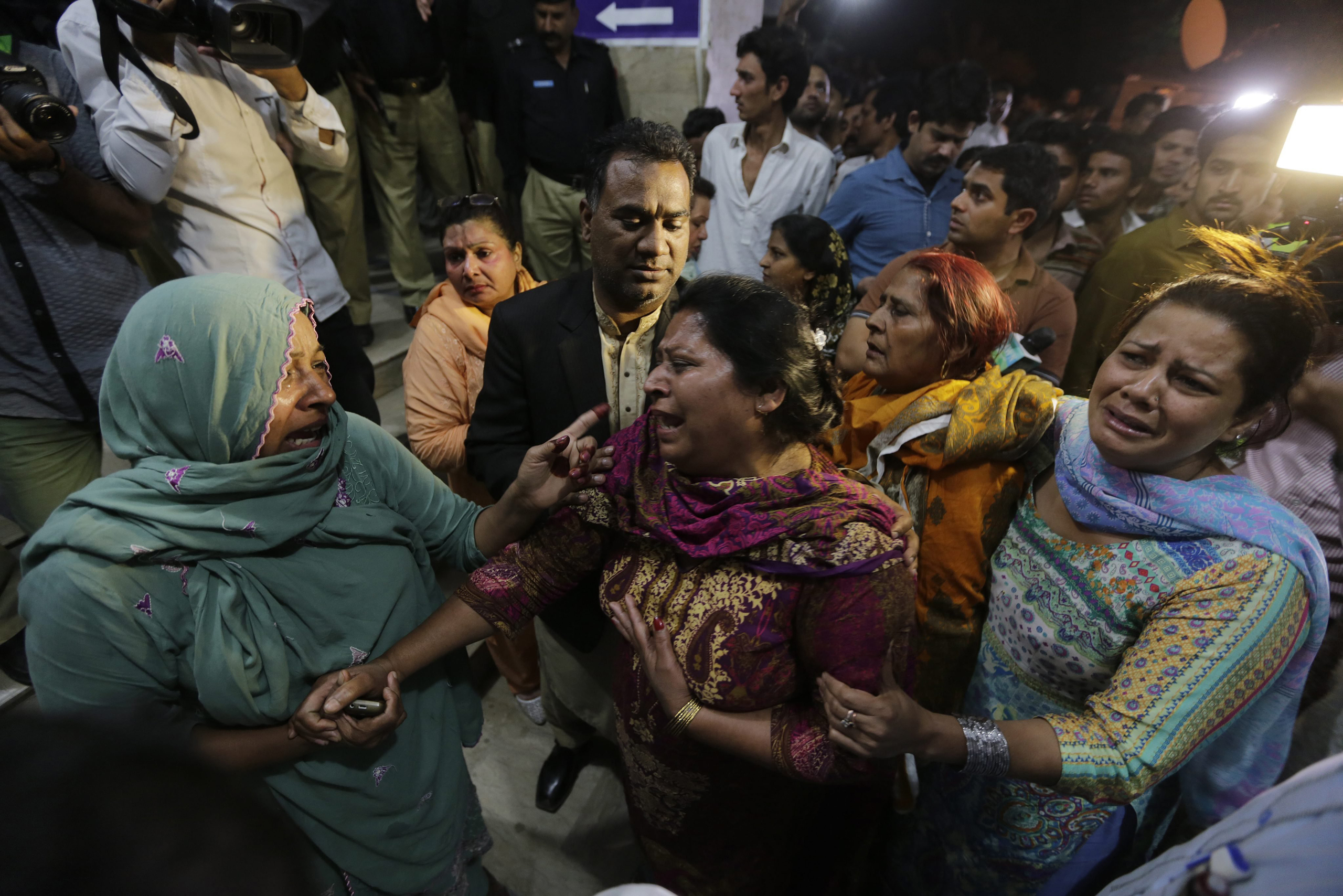 Relatives of the victims of a suicide bomb blast cry outside a hospital in Lahore, Pakistan, on March 27, 2016.