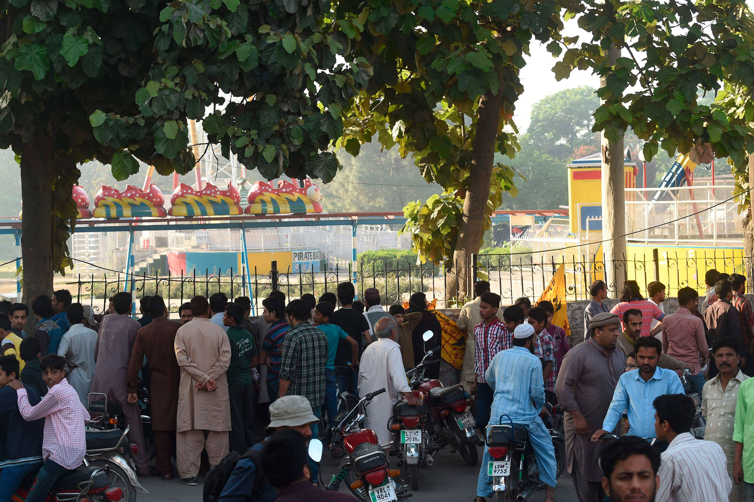 Local residents gather outside the cordoned-off site of the bombing at the park in Lahore, Pakistan, on March 28, 2016 (Arif Ali—AFP/Getty Images)