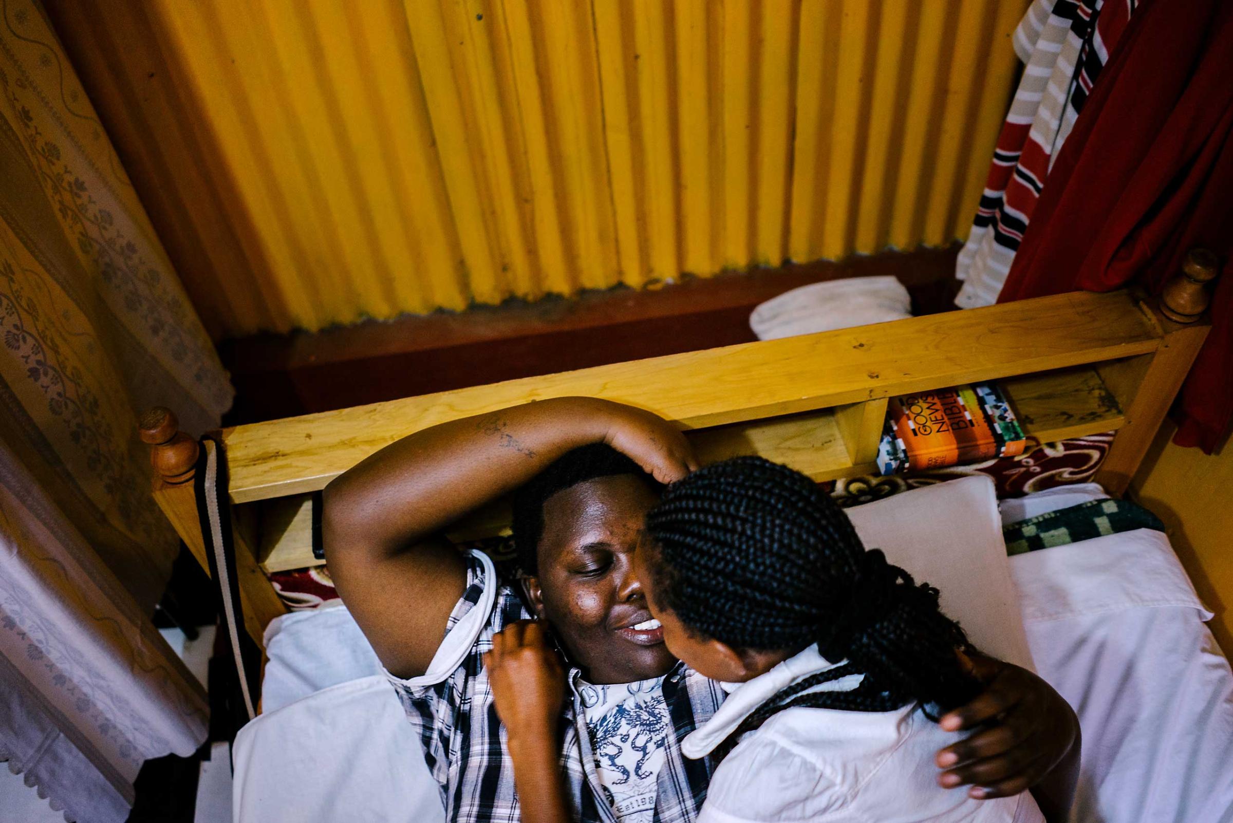 Cynthia is a lesbian activist and refugee from Burundi. She fled her country after authorities found out she was gay. They beat her and cut her with machetes. Here, she lays in bed with her Kenyan girlfriend in the apartment the two shared in Nairobi, Kenya (though they have since moved). Cynthia is due to be resettled in the United States any day now, though that has been the case for months.