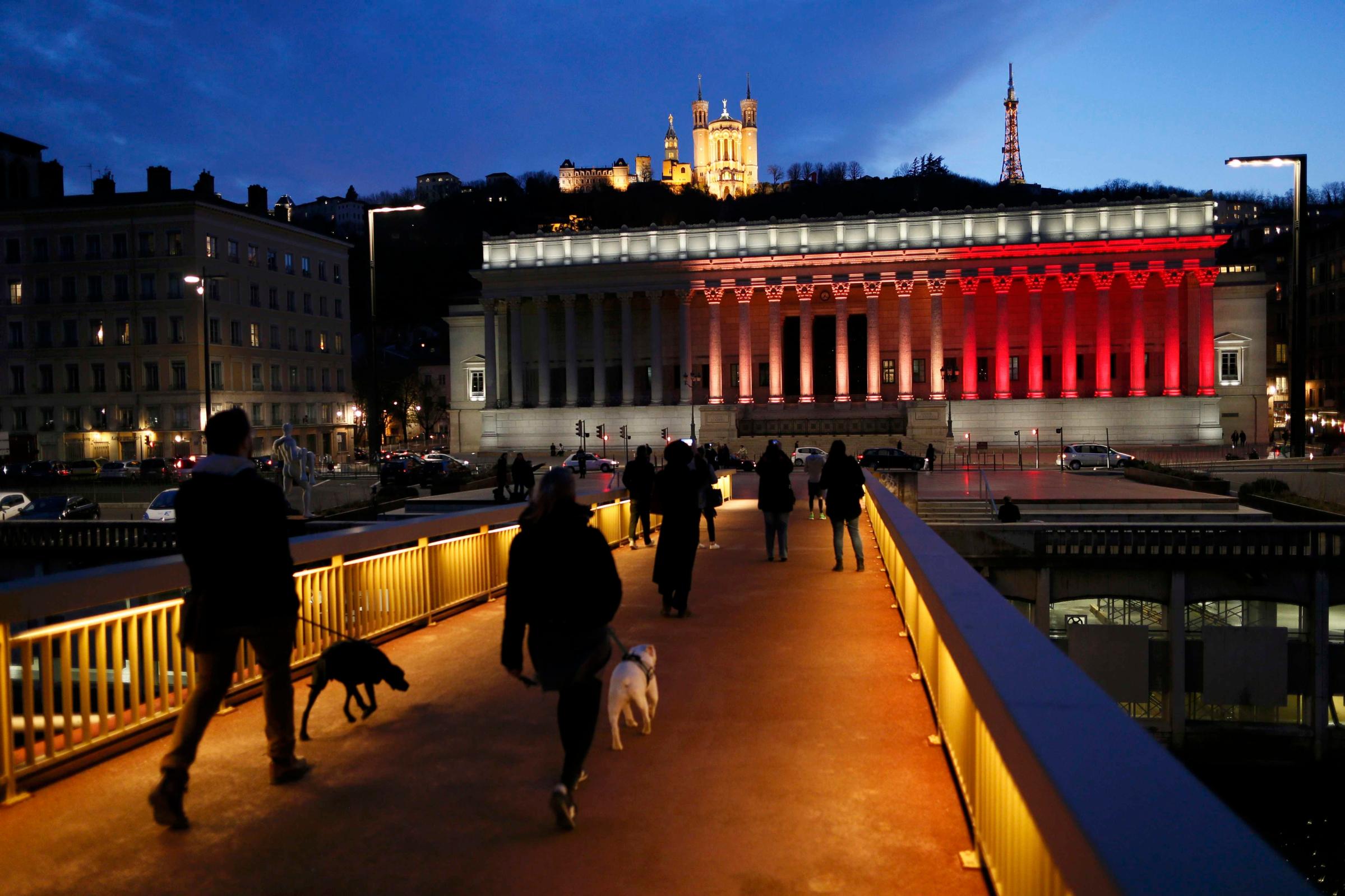 The black, yellow, and red colors of the Belgian flag are projected on the courthouse in Lyon in tribute to the victims of today's Brussels bomb attacks