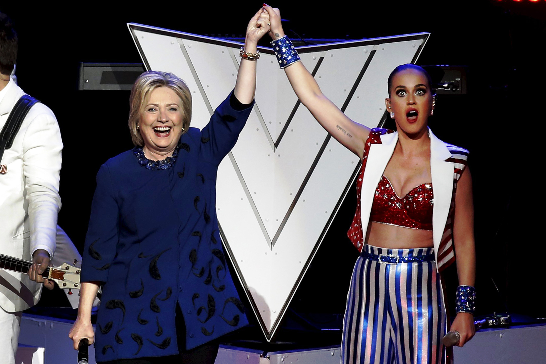 Katy Perry raises arms with Democratic presidential candidate, former Secretary of State Hillary Clinton during a benefit concert at Radio City Music Hall in New York on March 2.