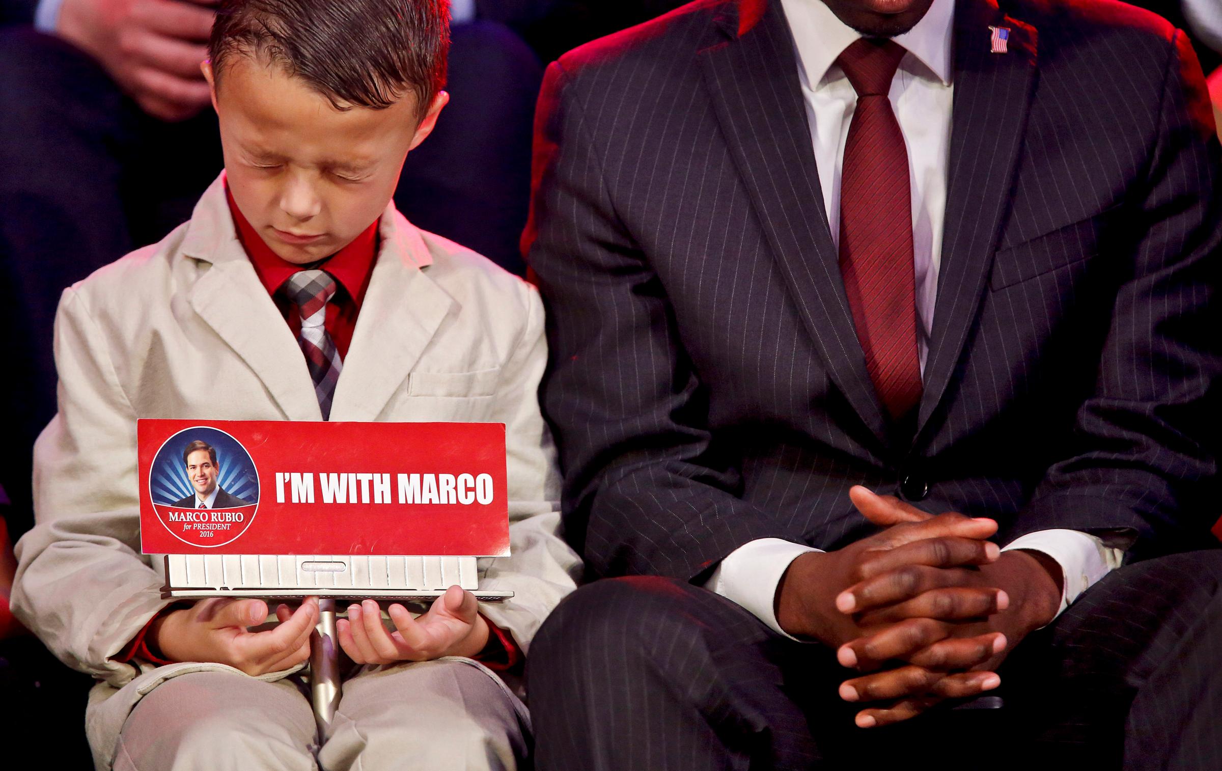 Six-year-old Aiden Thurman, of Hugo, Okla. prays during a campaign stop by Republican presidential candidate Marco Rubio on Feb. 26, 2016, in Oklahoma City.