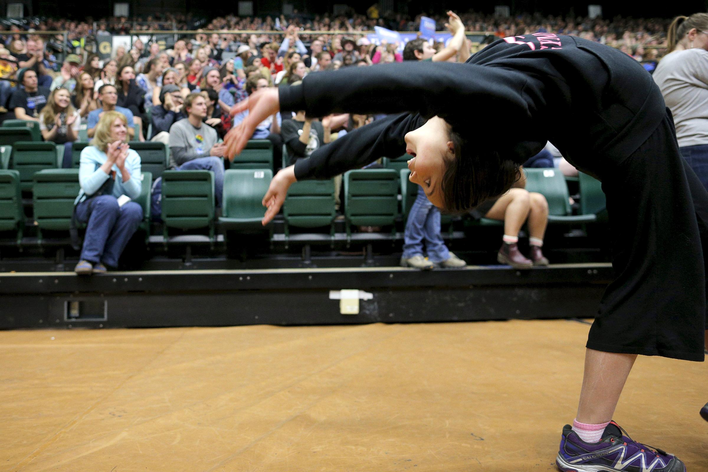 A girl does a backflip during a campaign rally for Democratic presidential candidate, Vermont Sen. Bernie Sanders in Fort Collins, Colo. on Feb. 28.