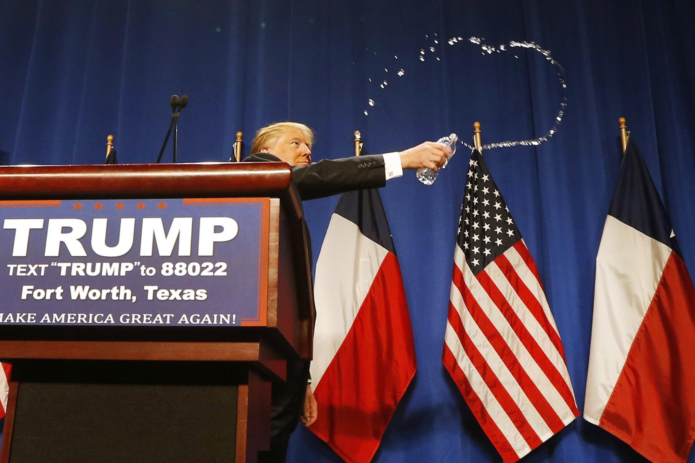 Republican presidential candidate Donald Trump slings water from a bottle during a rally in Fort Worth, Texas on Feb. 26.