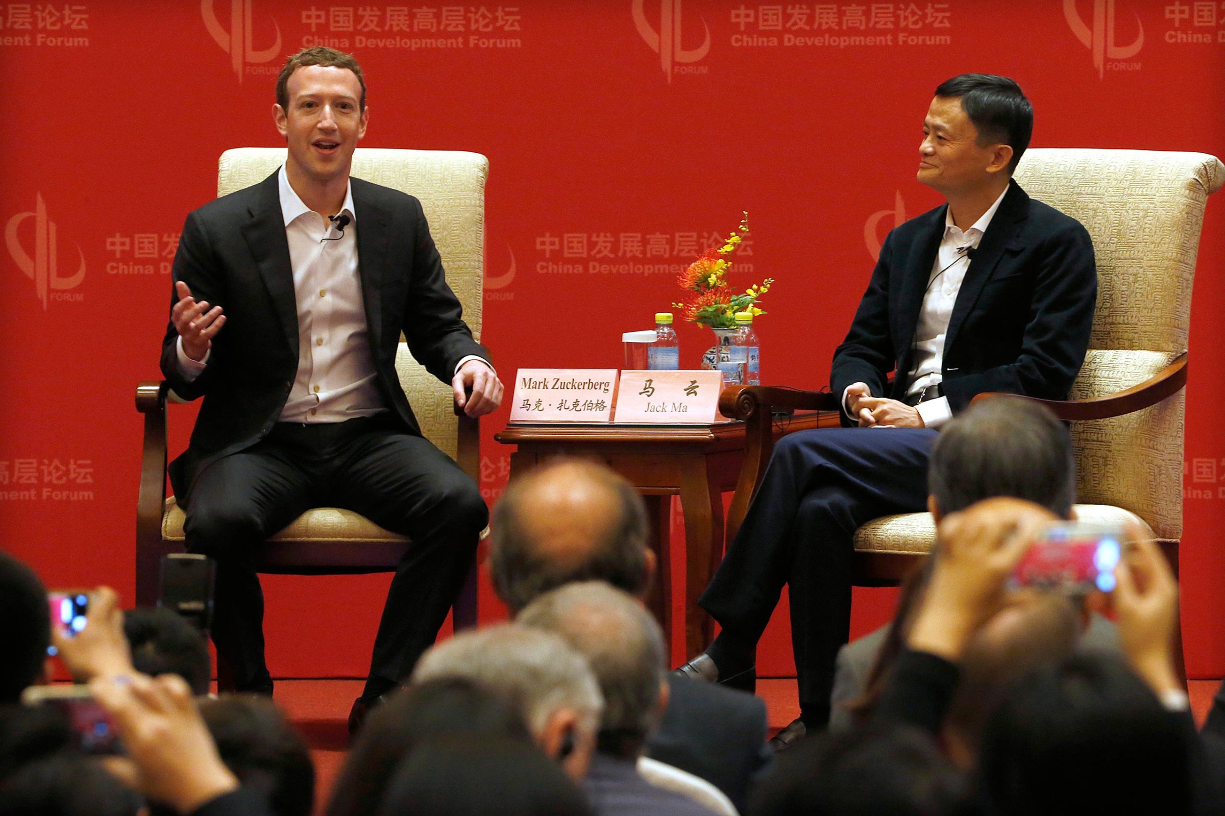 Facebook CEO Mark Zuckerberg speaks as Jack Ma, executive chairman of the Alibaba Group, listens during a panel discussion held as part of the China Development Forum at the Diaoyutai State Guesthouse in Beijing, China, March 19, 2016.