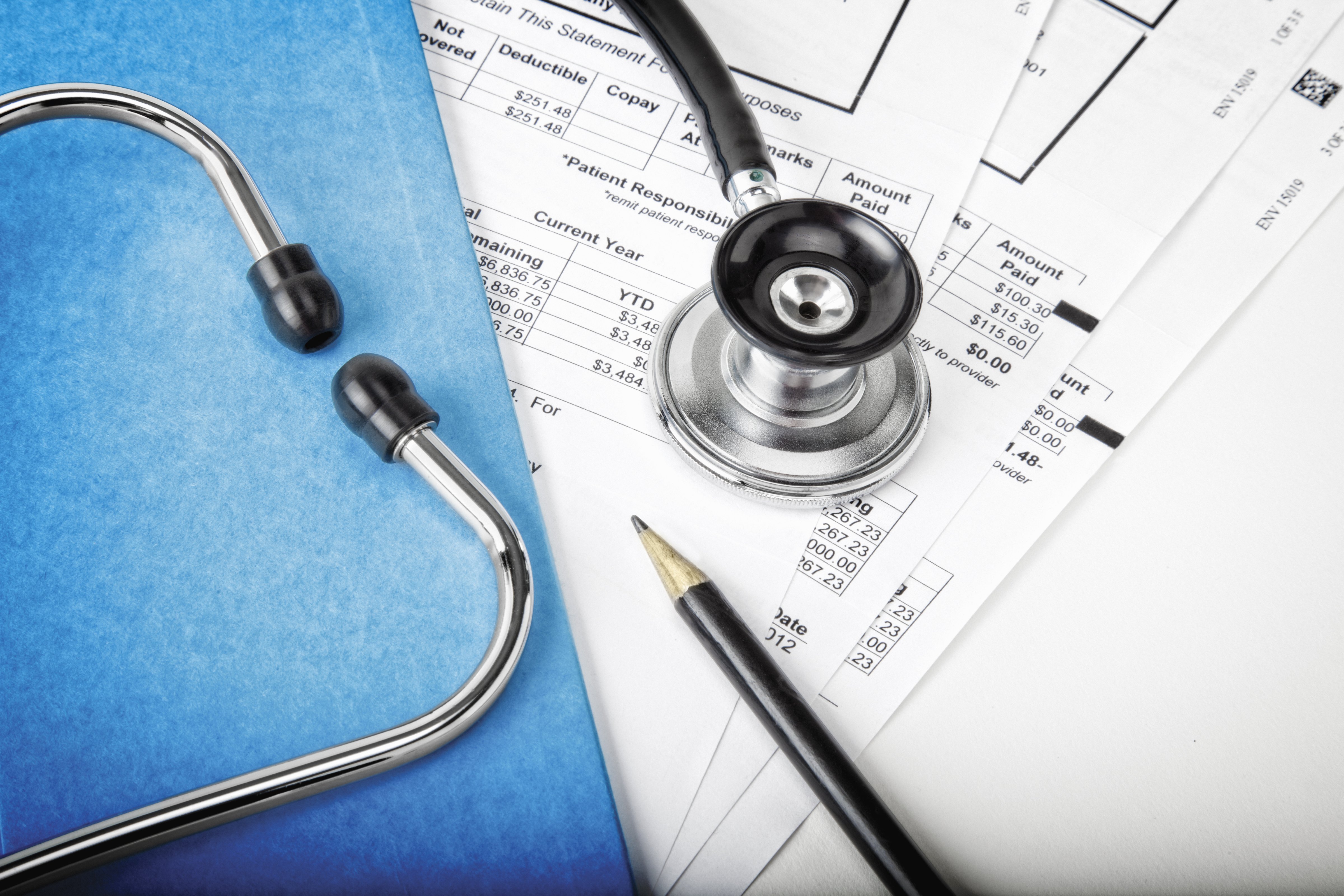 Medical bills with stethoscope