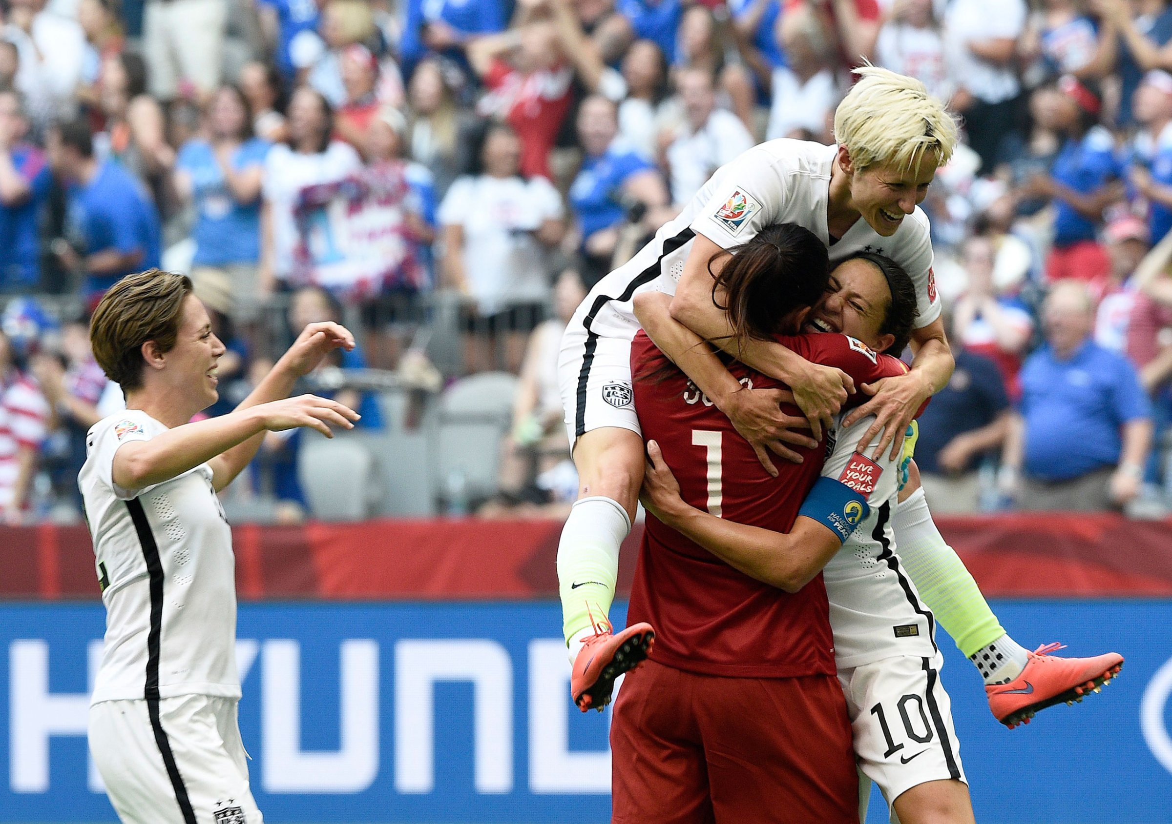 Carli Lloyd (10) is congratulated by goalkeeper Hope Solo (1) and midfielder Megan Rapinoe (top) after scoring a goal during the final match between USA and Japan during the 2015 FIFA Women's World Cup at the BC Place Stadium in Vancouver, Canada, July 5, 2015.