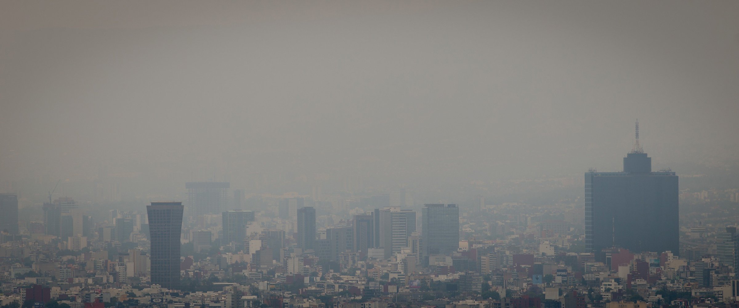 This photo shows a view of the dense smog layer covering the buildings from the look-out of the Torre Latinoamericana, in Mexico city on March 17, 2016.