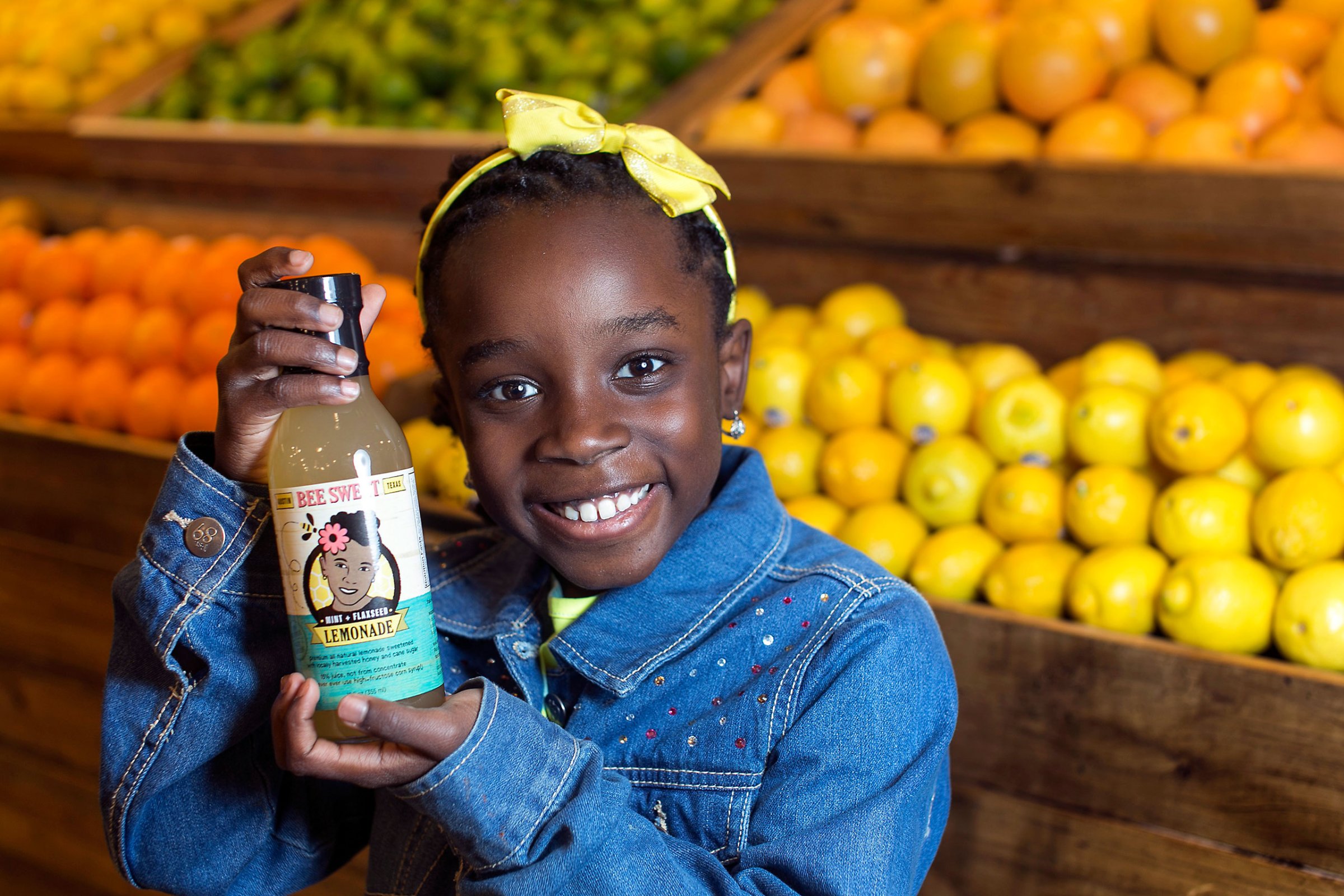 In this Jan. 27, 2014, photo, Mikaila Ulmer stands for a photo as she holds a bottle of Bee Sweet Lemonade that she and her family make and sell at Whole Foods at the Domain in Austin, Texas.