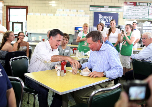 Republican presidential candidate and former Massachusetts Governor Mitt Romney (L) eats ice cream with Ohio Governor John Kasich during a campaign rally at Tom's Ice Cream Bowl on August 14, 2012 in Zanesville, Ohio.