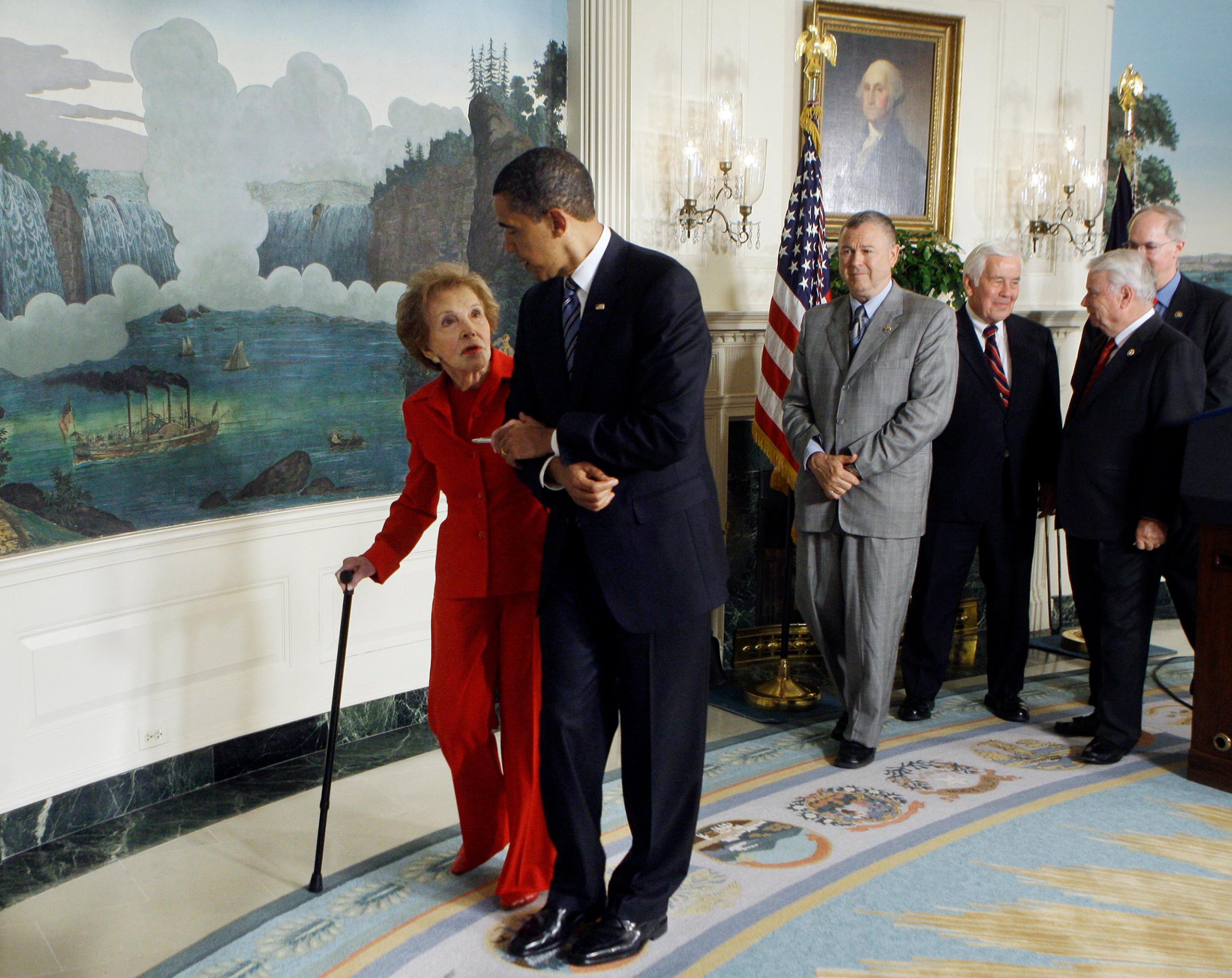 President Barack Obama escorts former first lady Nancy Reagan after signing the Ronald Reagan Centennial Commission Act, during a ceremony in the Diplomatic Reception Room of the White House in Washington, DC on June 2, 2009.