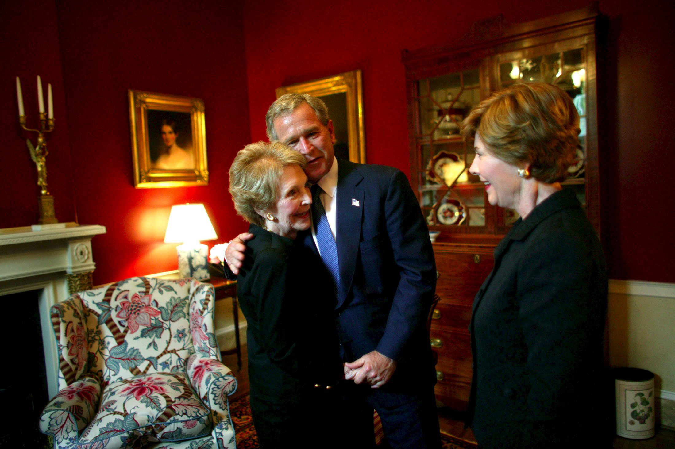 Former President George W. Bush and former first lady Laura Bush greet former first lady Nancy Reagan at Blair House in Washington on June 10, 2004.